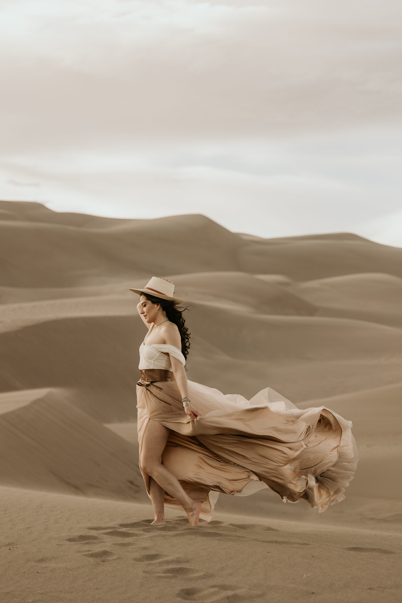 colorado micro wedding and elopement photographer poses at great sand dunes national park.