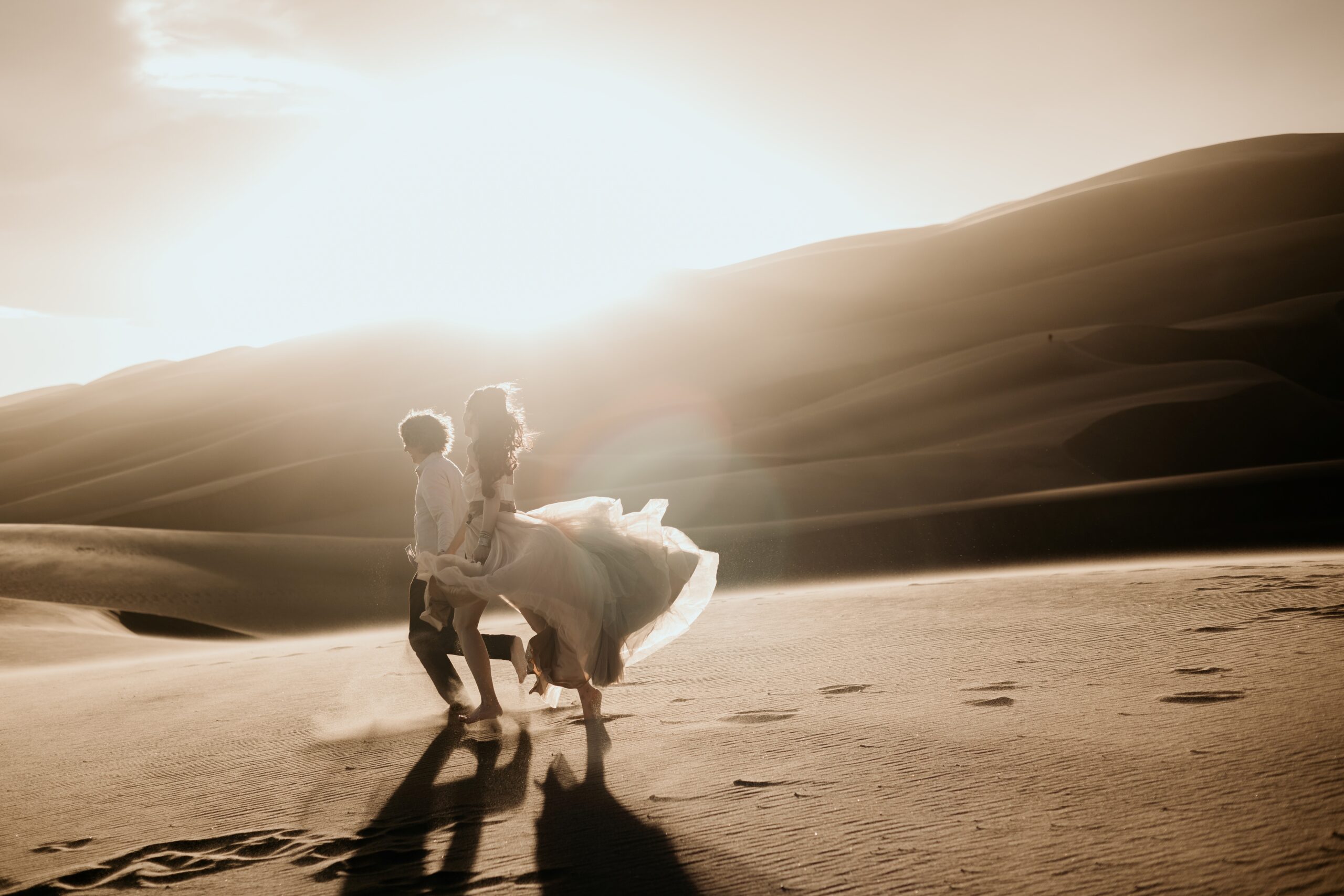 couple poses at great sand dunes national park for portrait session.