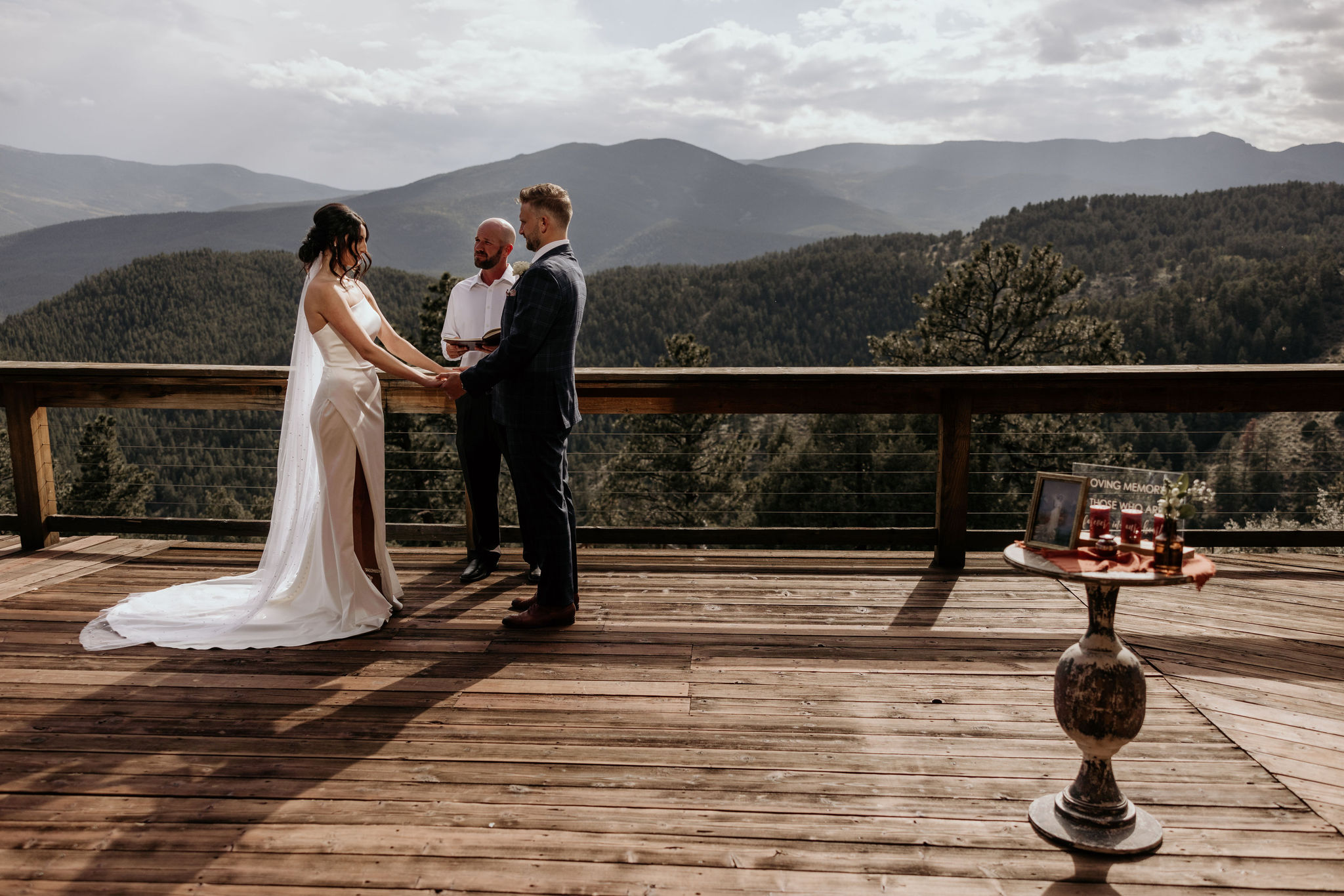 bride and groom stand on deck of airbnb during colorado elopement.