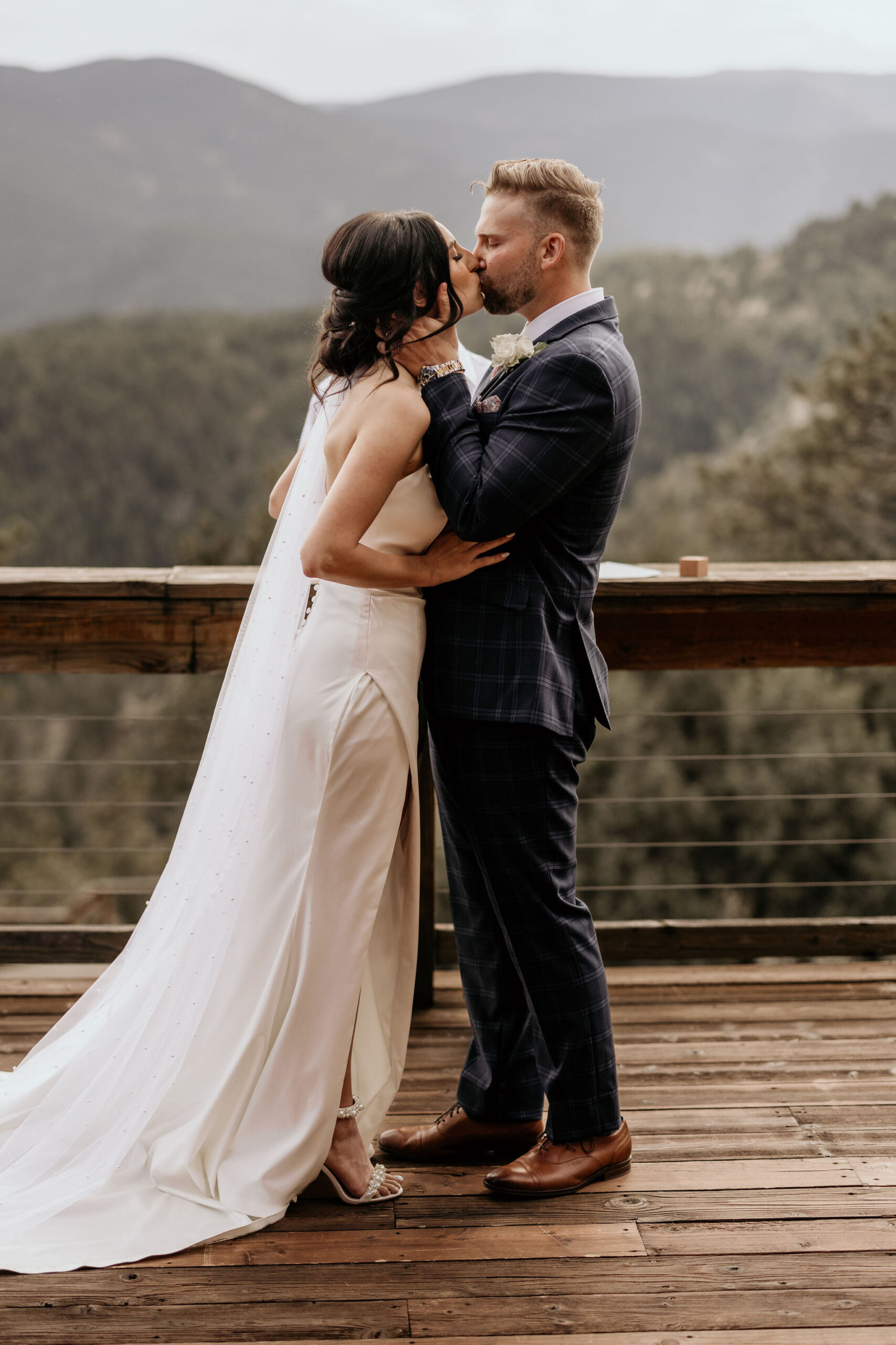 bride and groom kiss during colorado elopement ceremony.