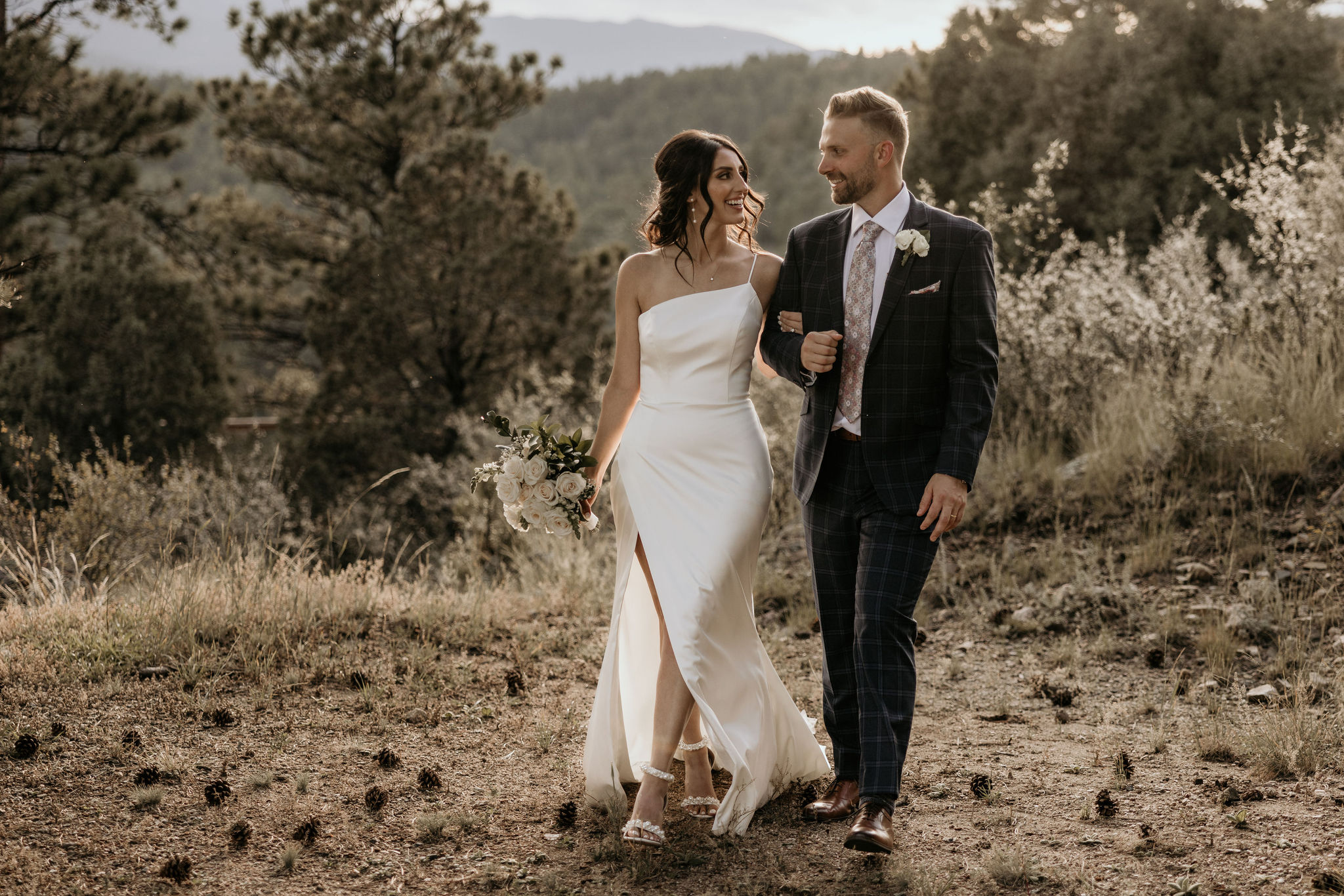 bride and groom walk on trail during stress free wedding day.