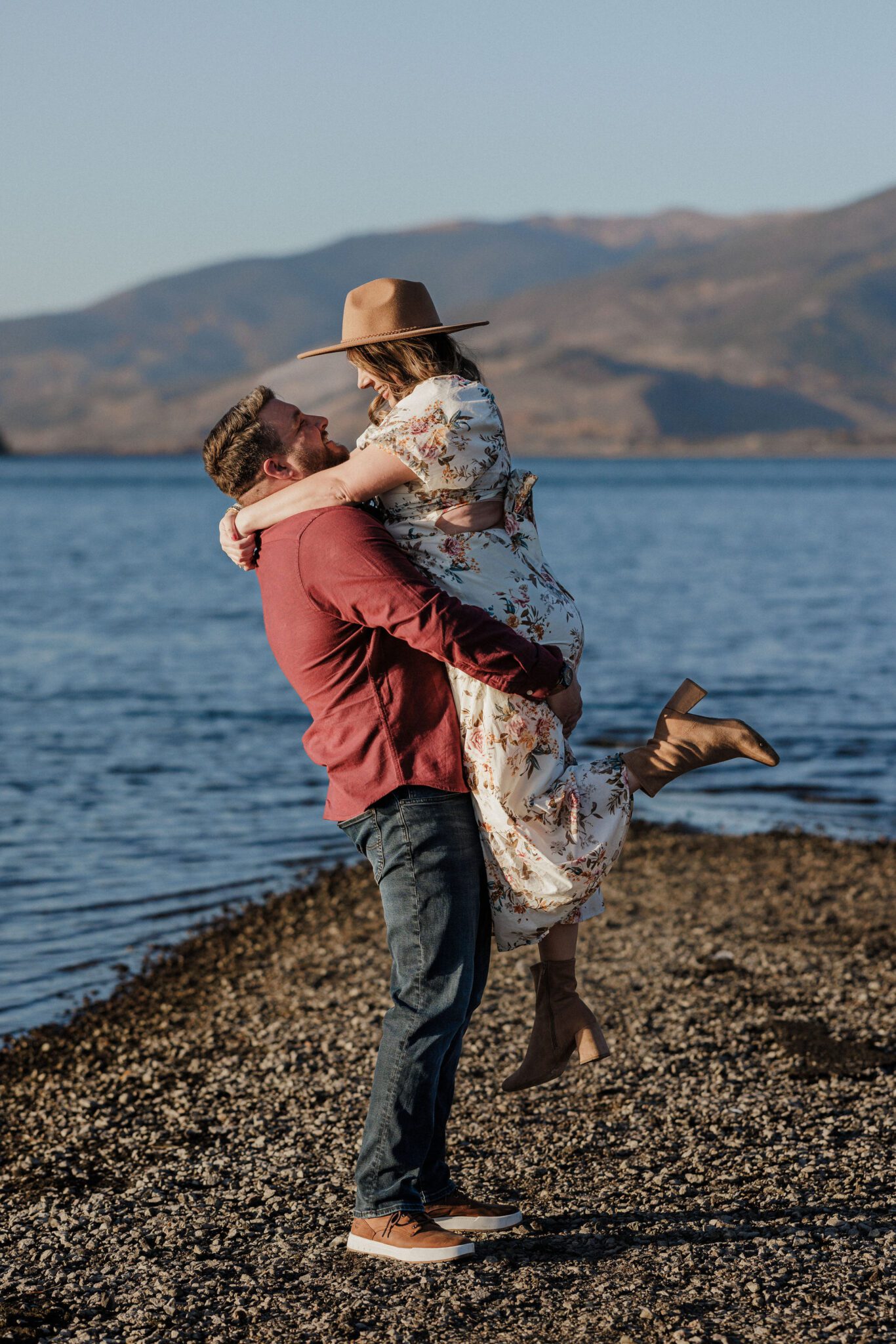 during colorado engagement photos, man lifts fiance