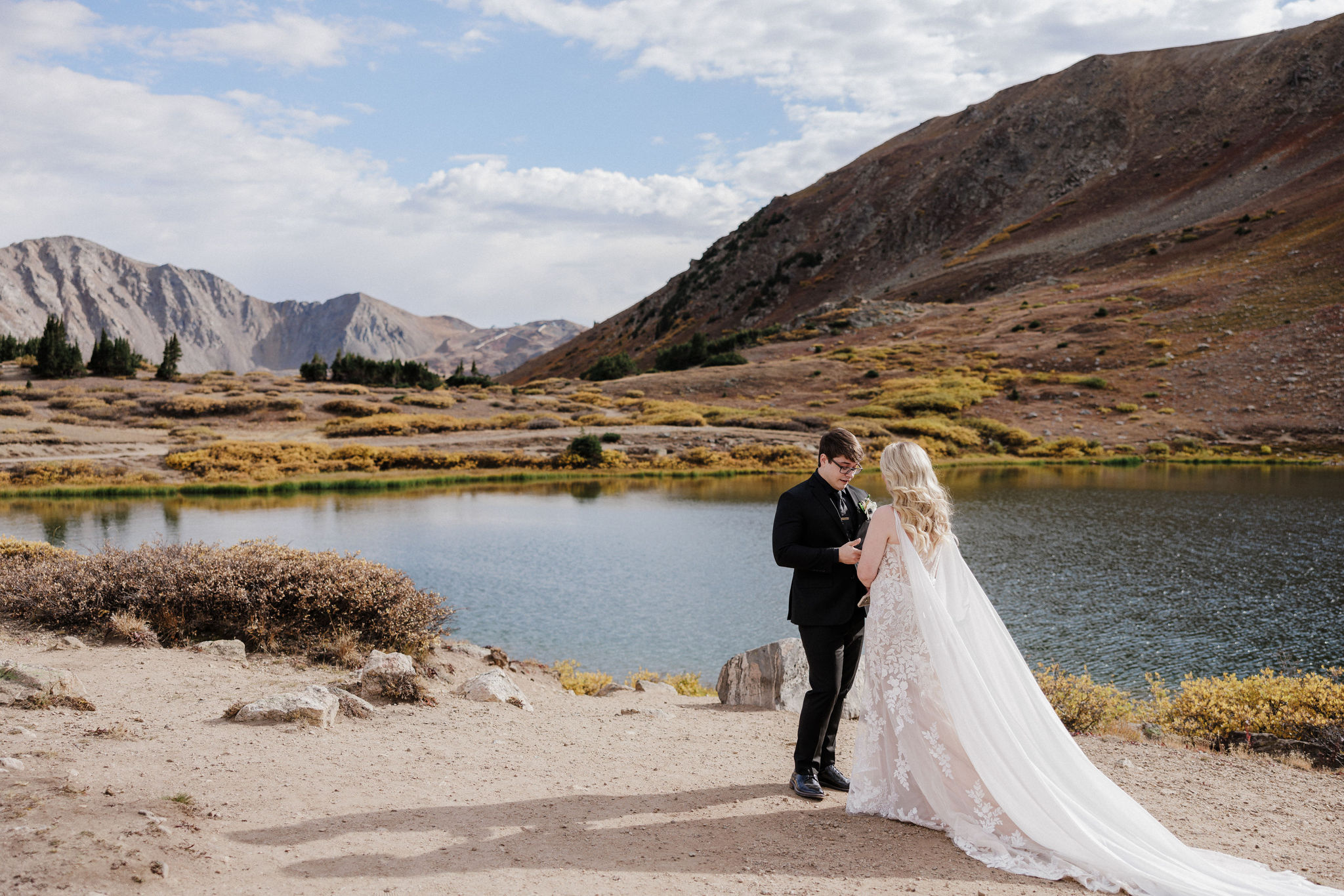 bride and groom say wedding vows at colorado alpine lake