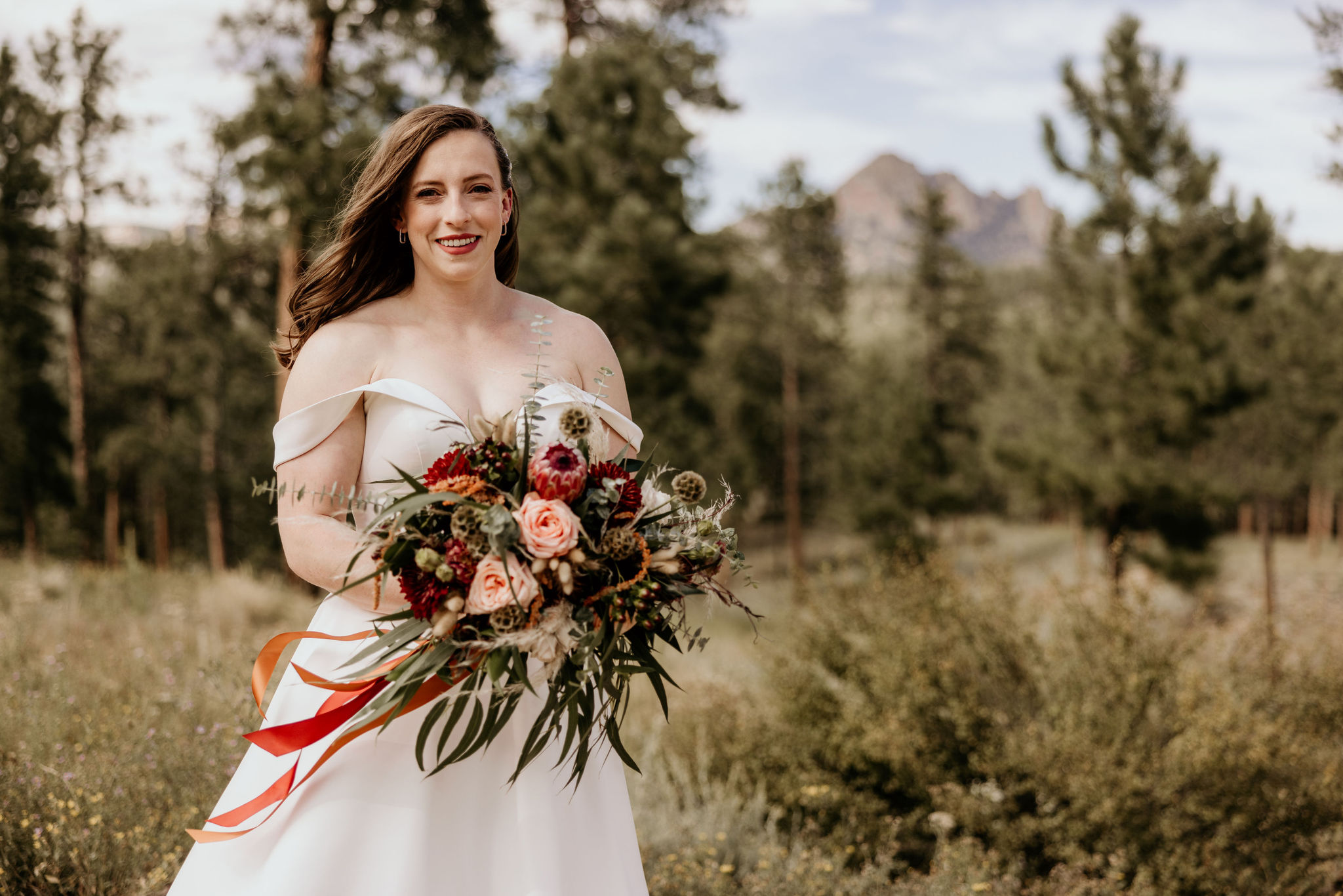bride holds wedding bouquet in colorado elopement location.