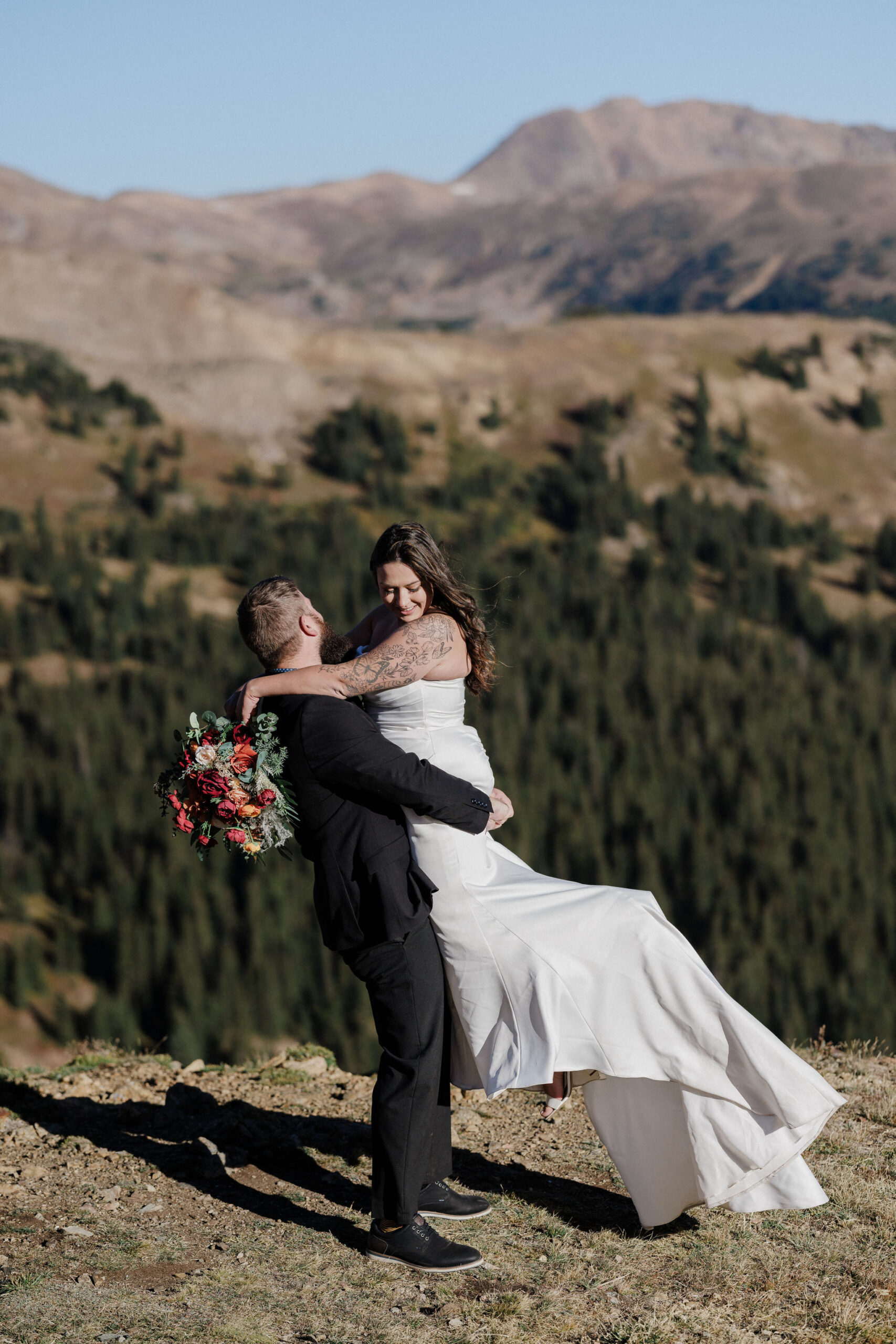 groom lifts bride and spins at loveland pass