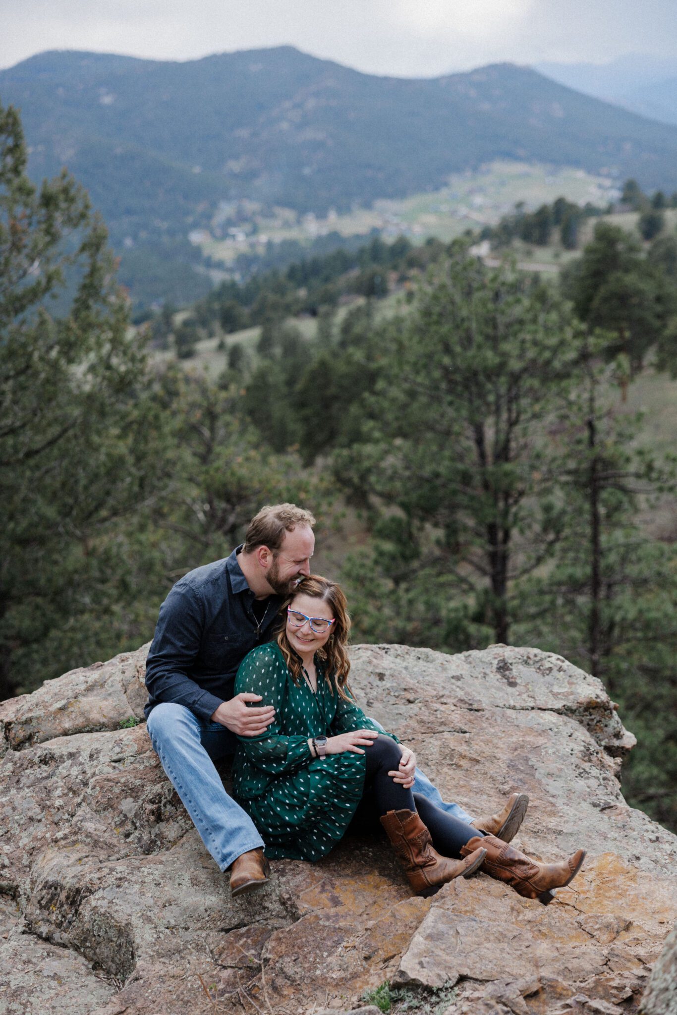 man and woman pose for colorado engagement photos at mt falcon