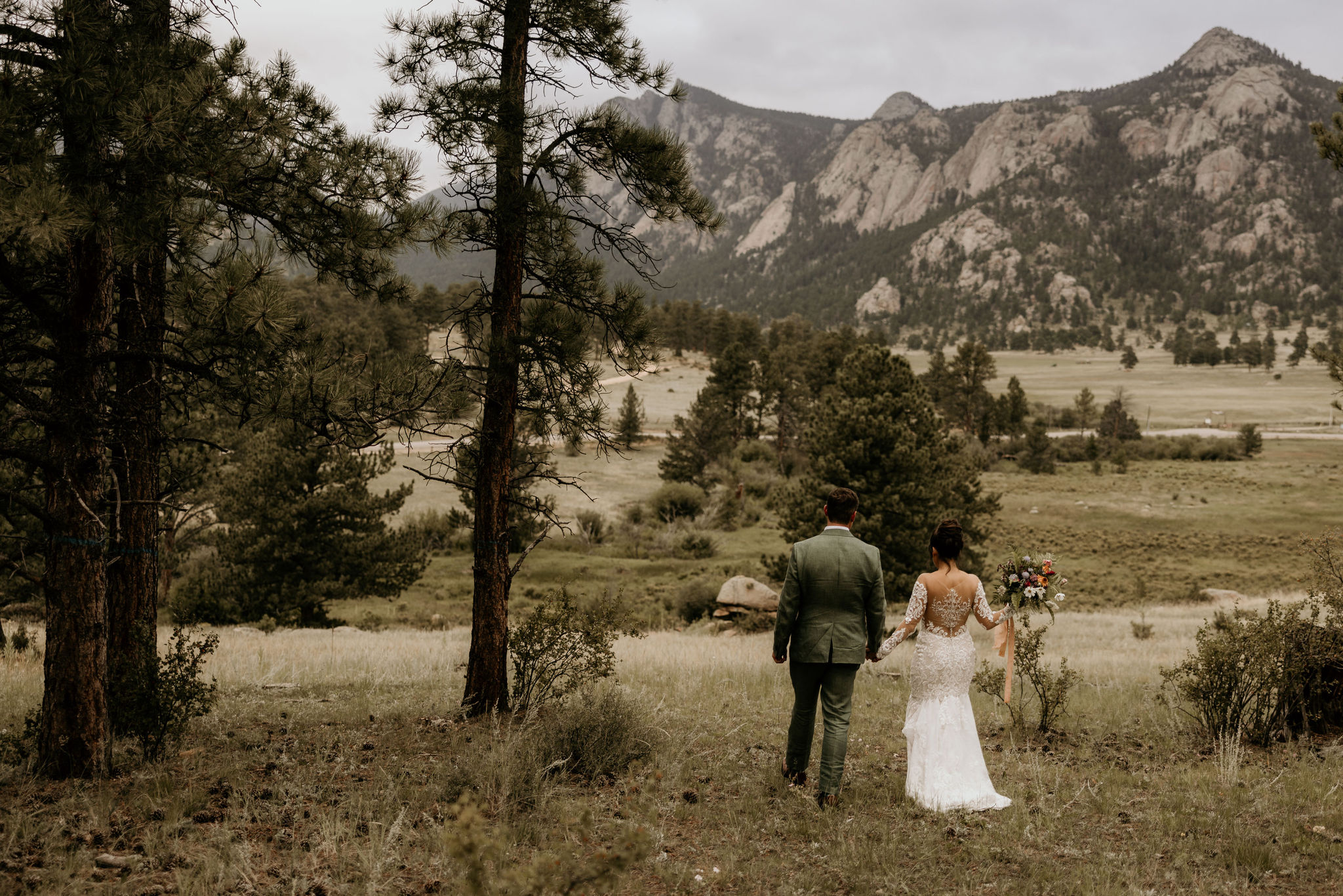 bride and groom walk in the colorado mountains during stress free wedding day.
