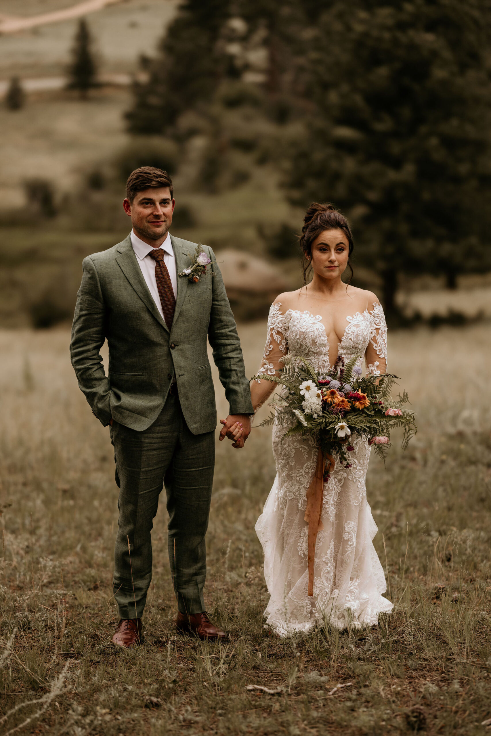 bride and groom hold hands and pose for colorado elopement photographer.