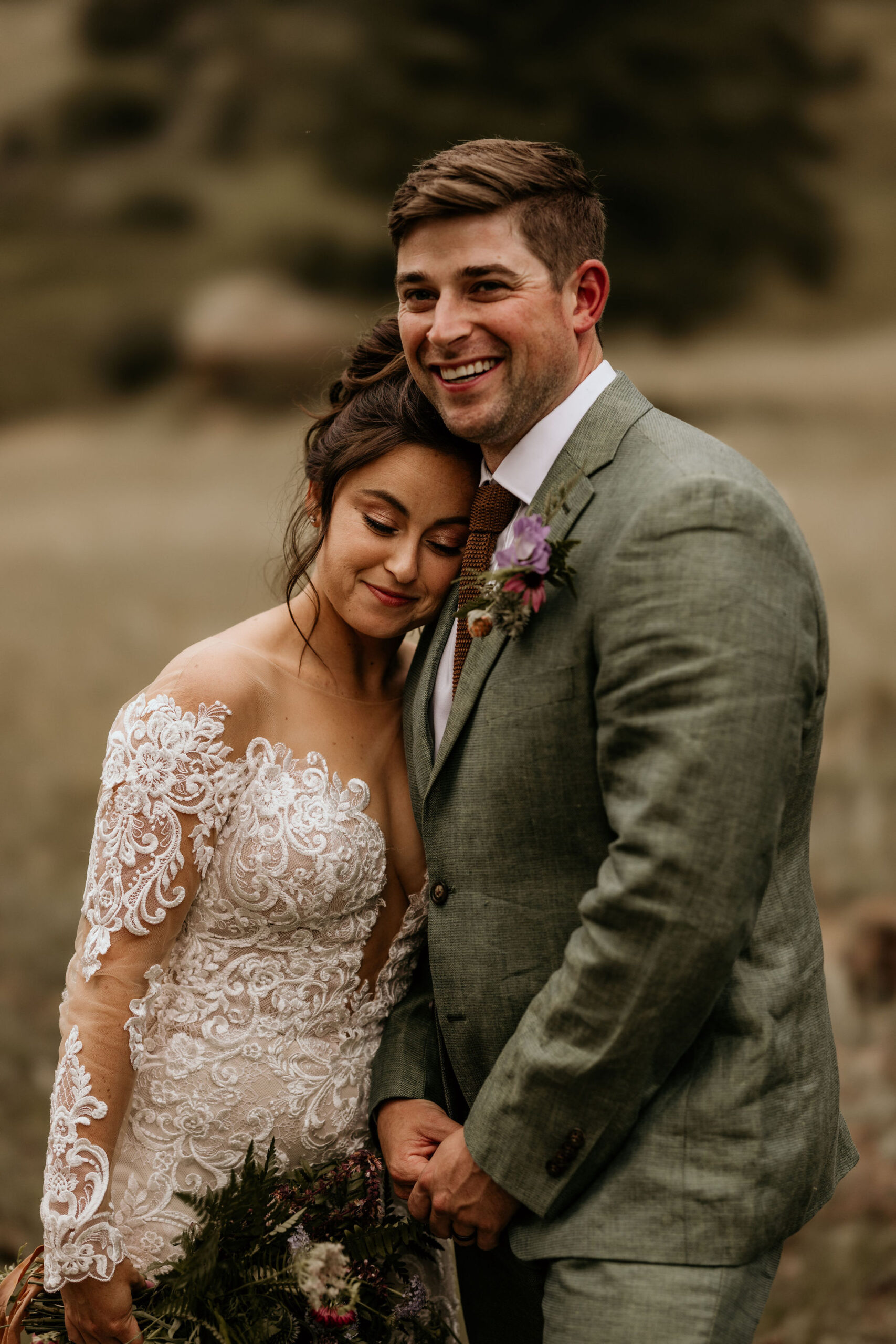 bride and groom smile and embrace during stress free elopement in colorado.