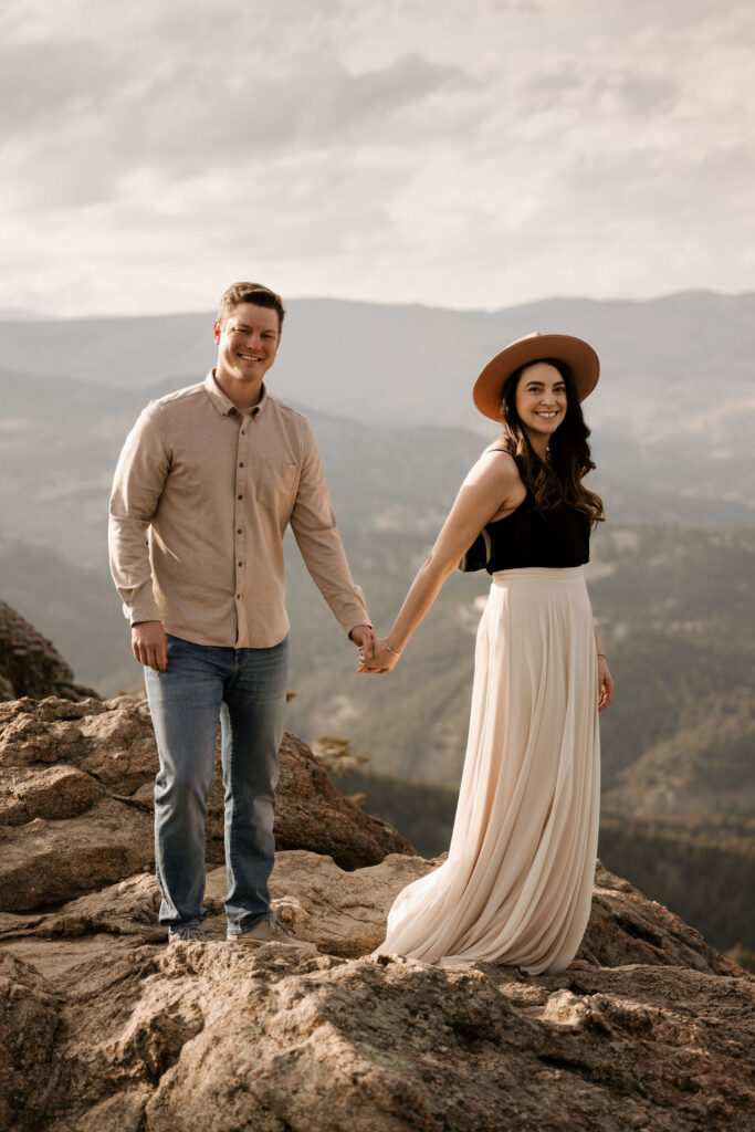newly engaged couple pose for colorado photographer during portrait session at lost gulch.