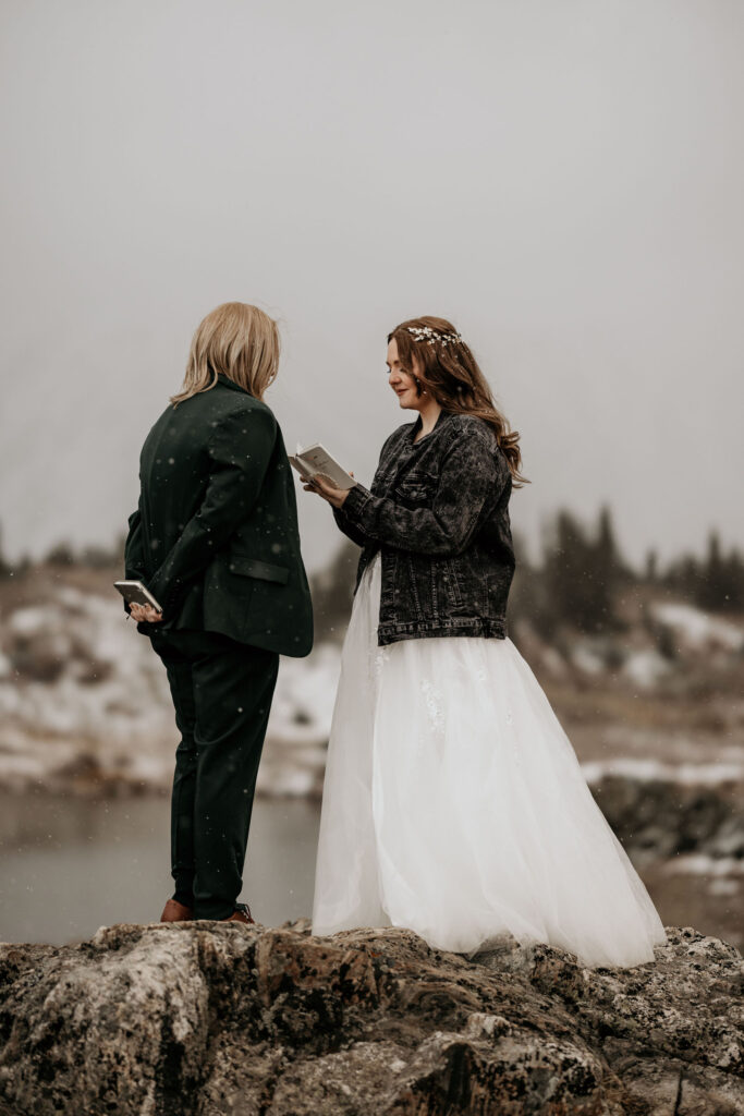 lgbtq+ couple says personal vows during colorado mountain wedding.