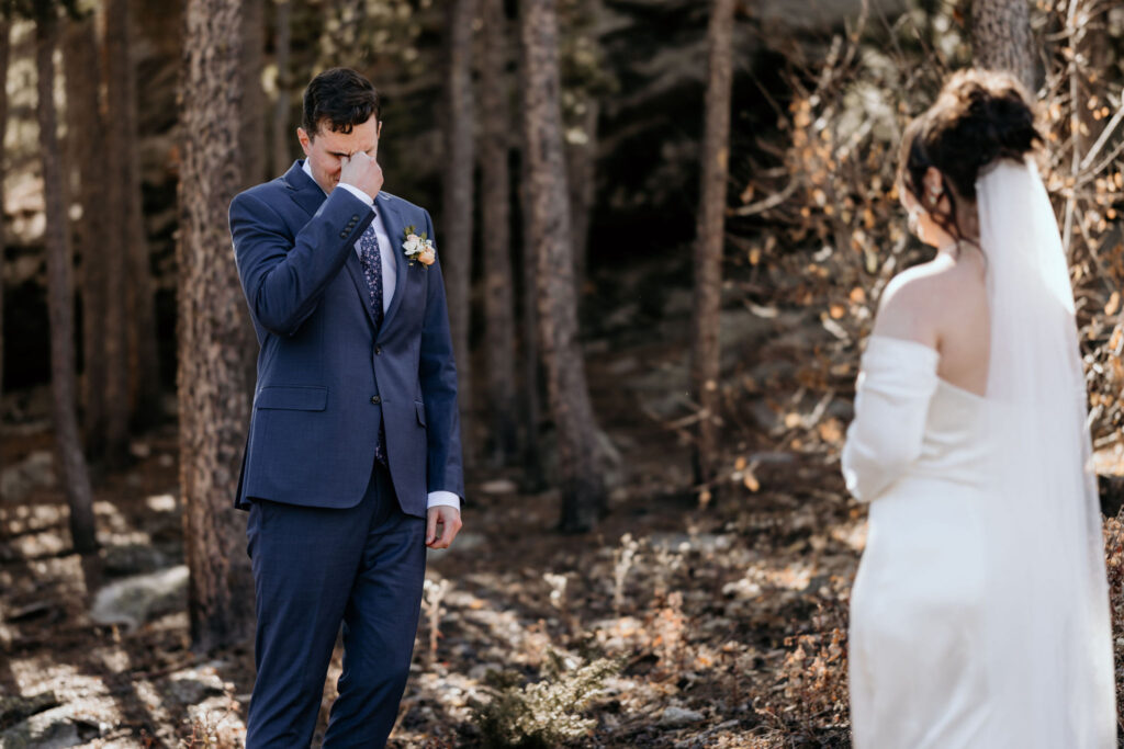 groom sees bride for first time and tears up during colorado elopement.