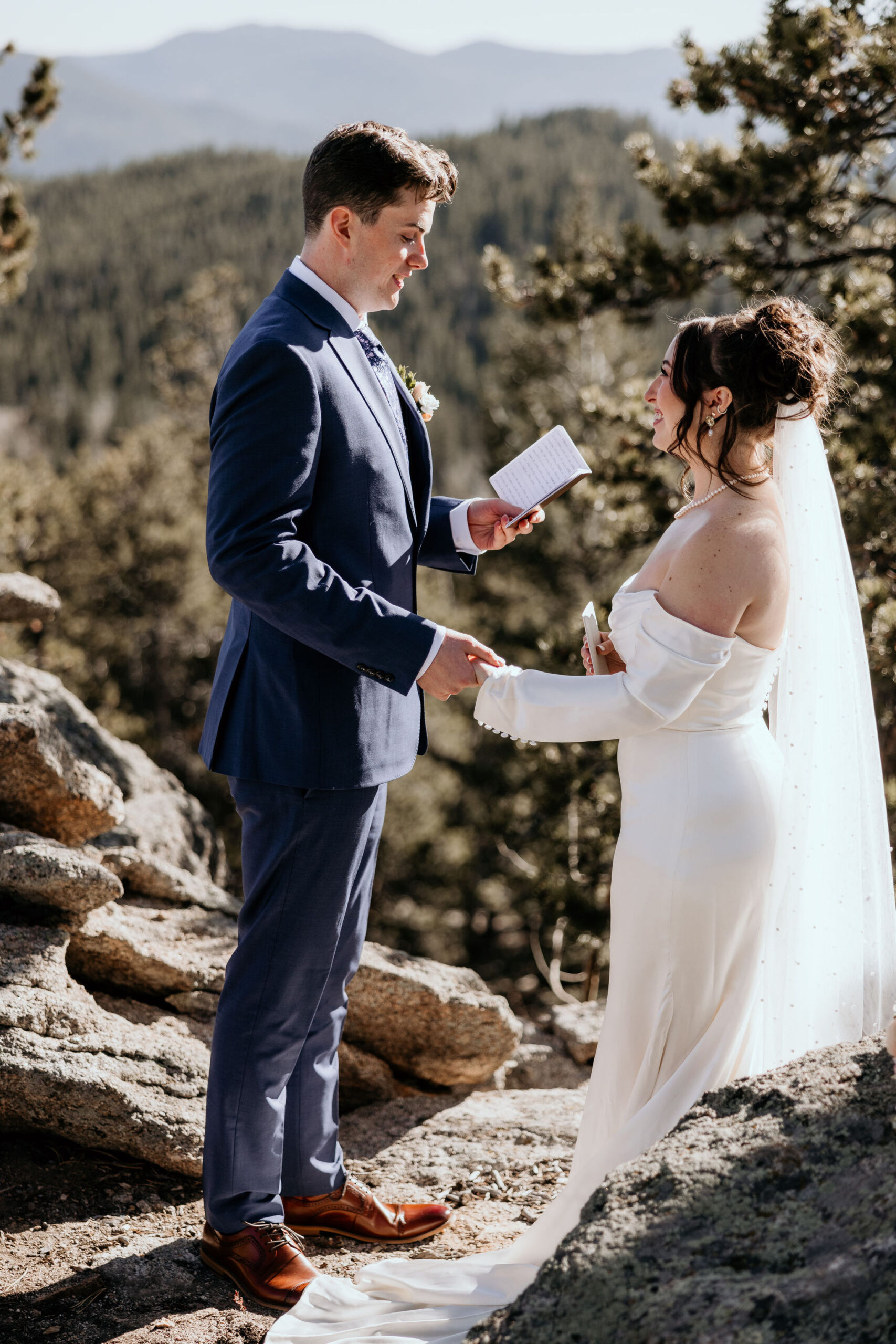 bride and groom hold hands and groom says wedding vows.