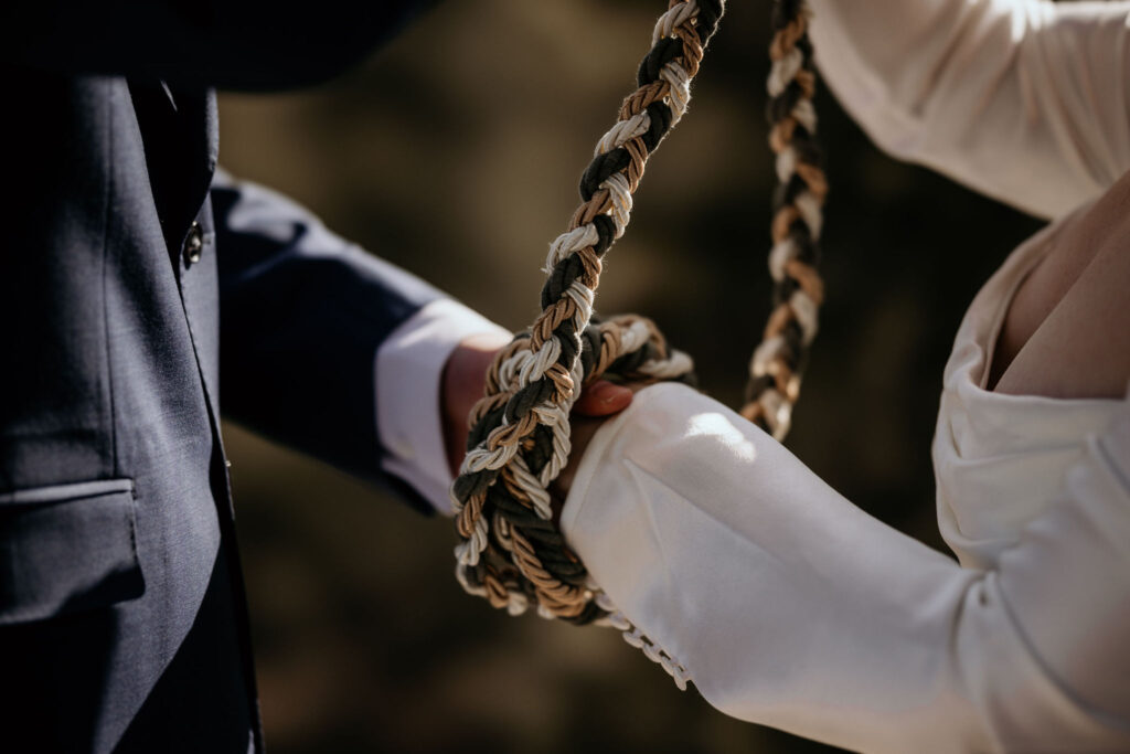close up image of bride and groom doing a handfasting ceremony at their colorado elopement.