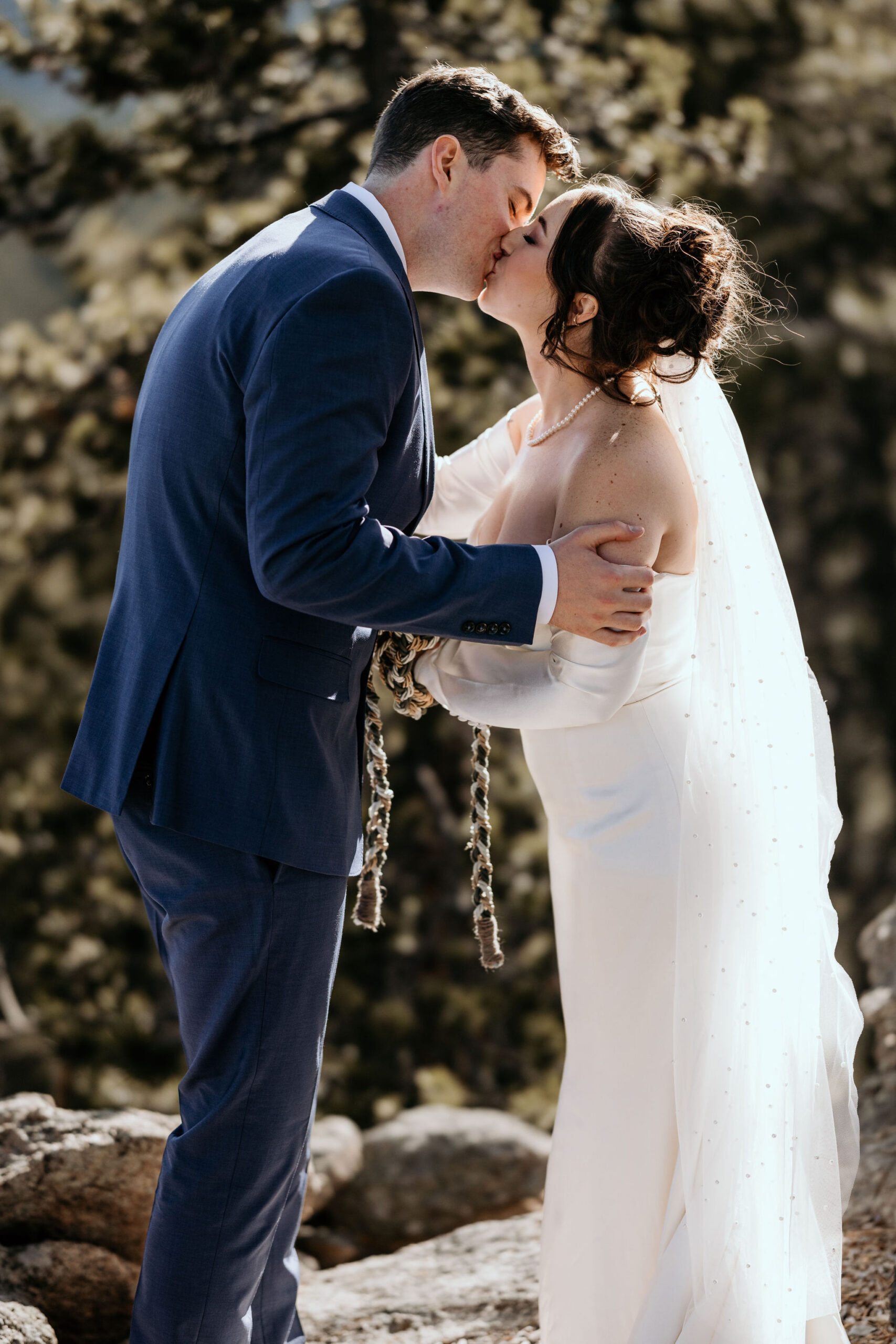 bride and groom kiss during airbnb elopement ceremony.