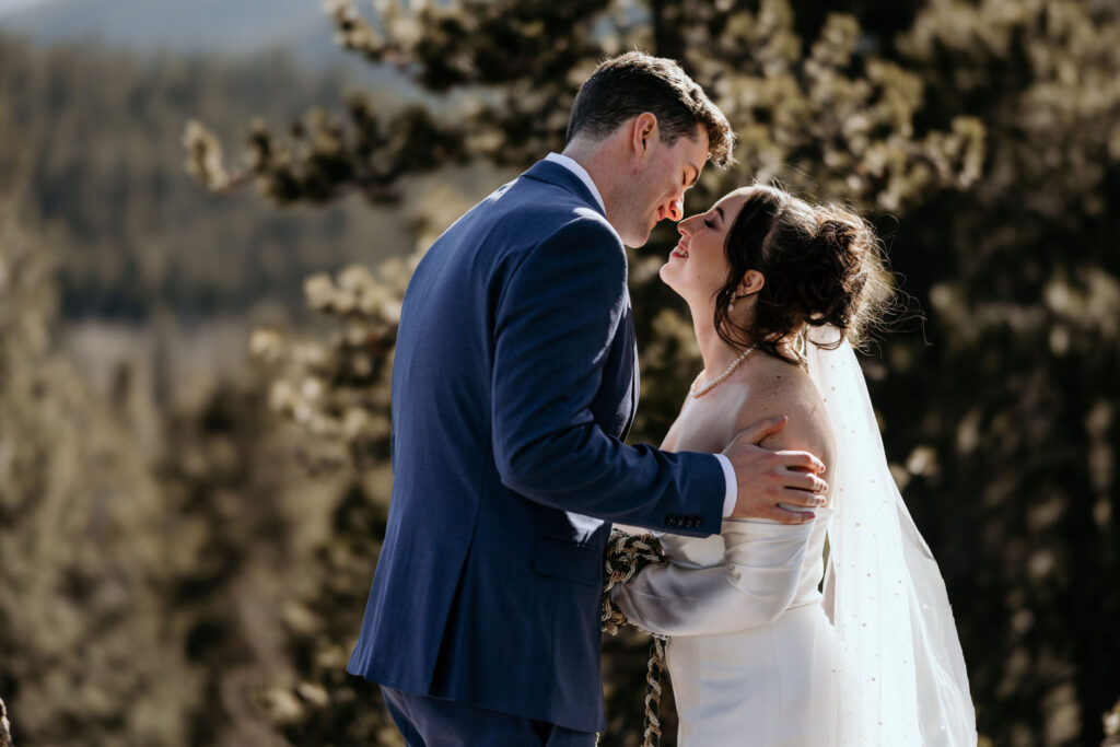 bride and groom go in for a kiss during their colorado airbnb elopement.