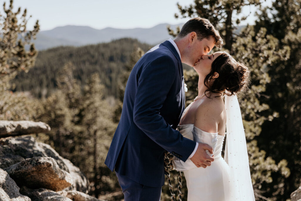 bride and groom kiss during colorado mountain portraits.