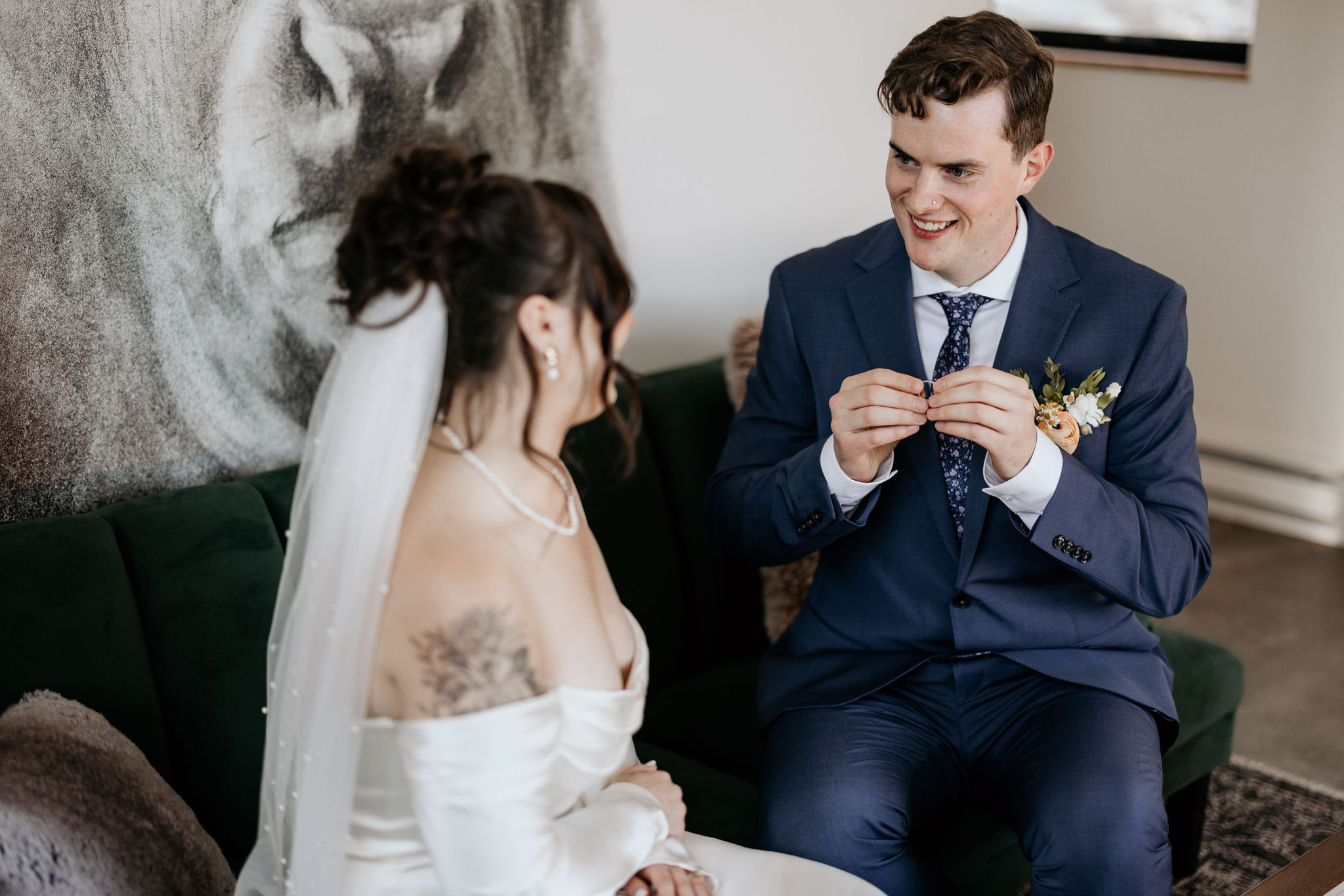 groom holds engraved wedding band during colorado airbnb elopement.