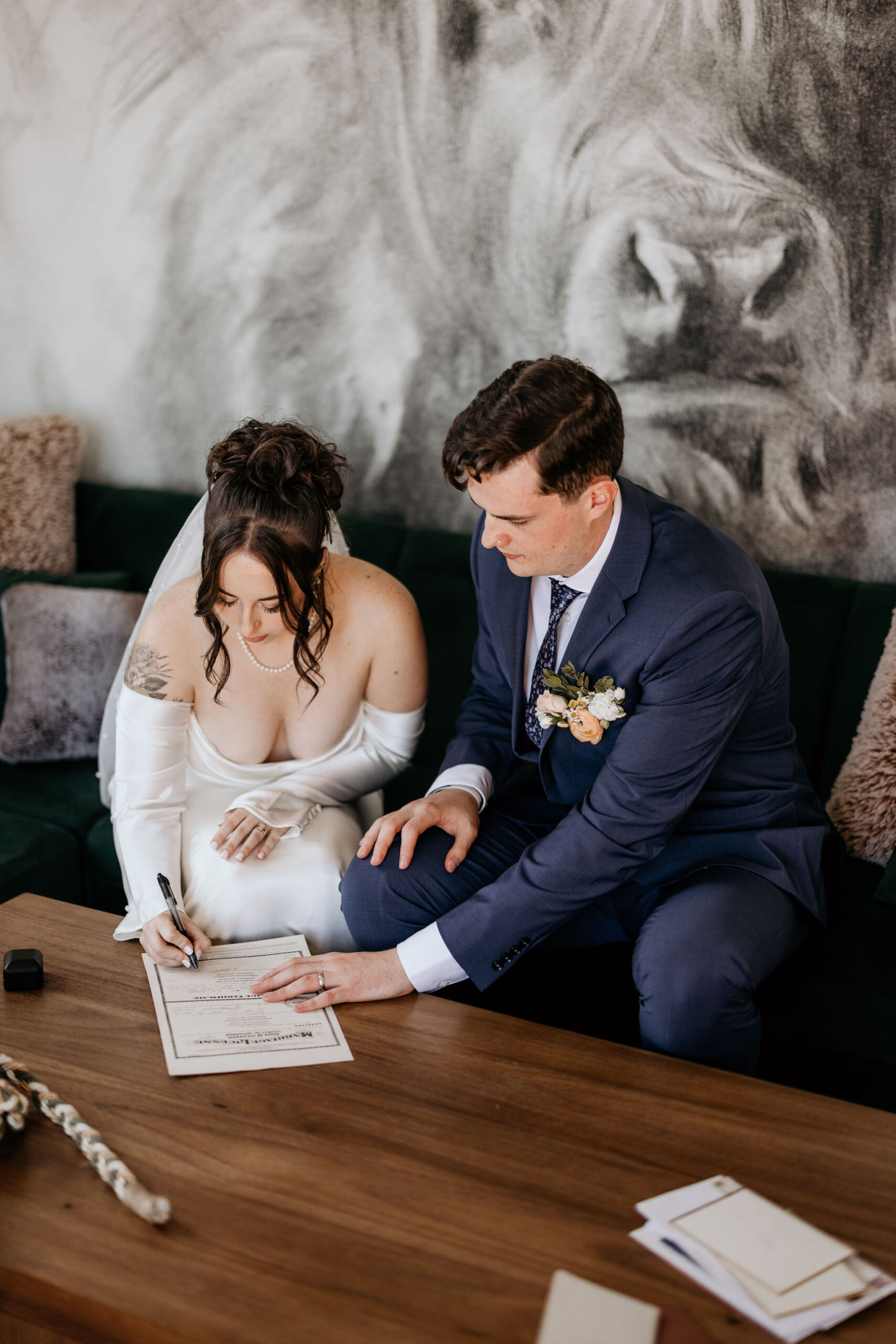 bride and groom sign marriage certificate during colorado elopement.