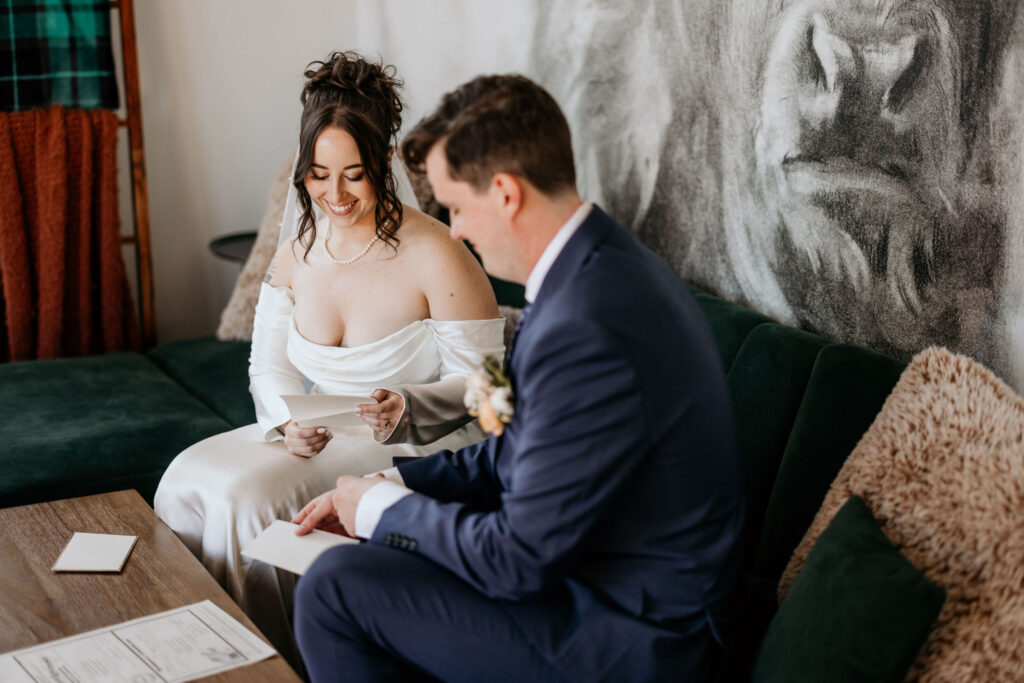 bride and groom read letters from loved ones.