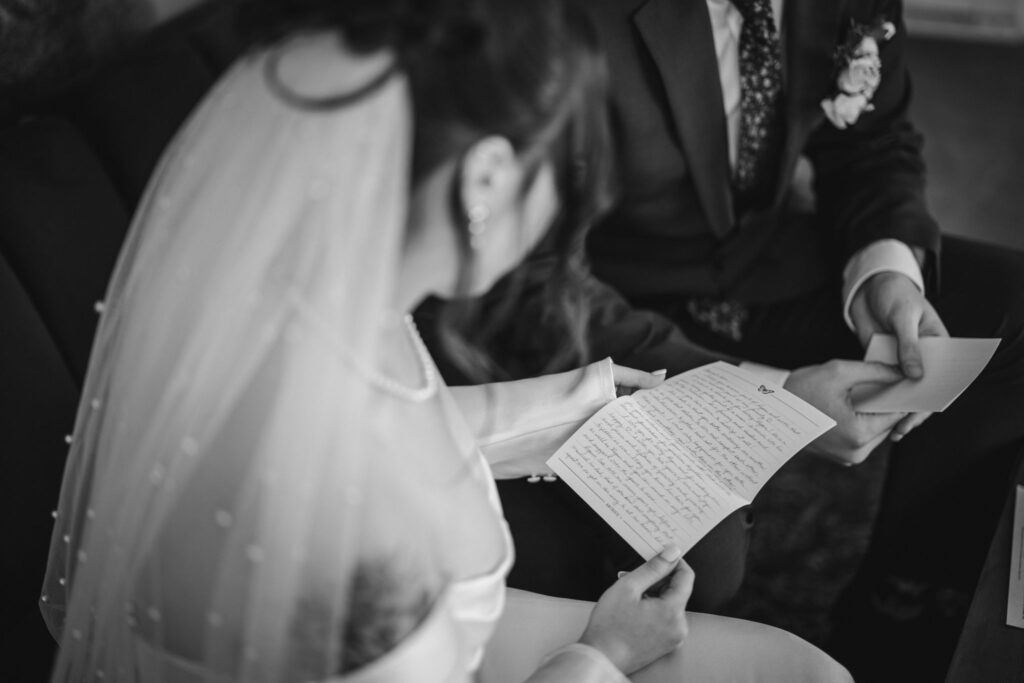bride and groom read letters from loved ones during their colorado elopement.