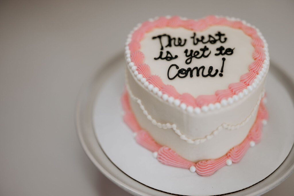 vintage style heart-shaped wedding cake that says "the best is yet to come".