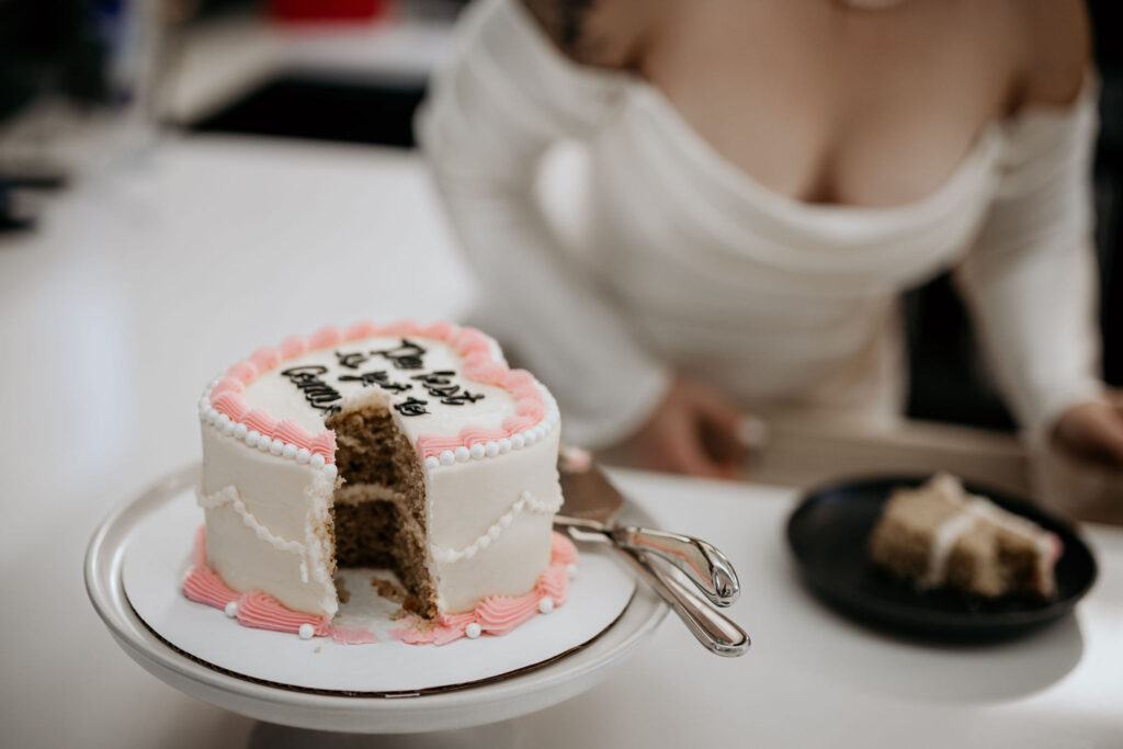close up image of a wedding cake with a slice taken out.