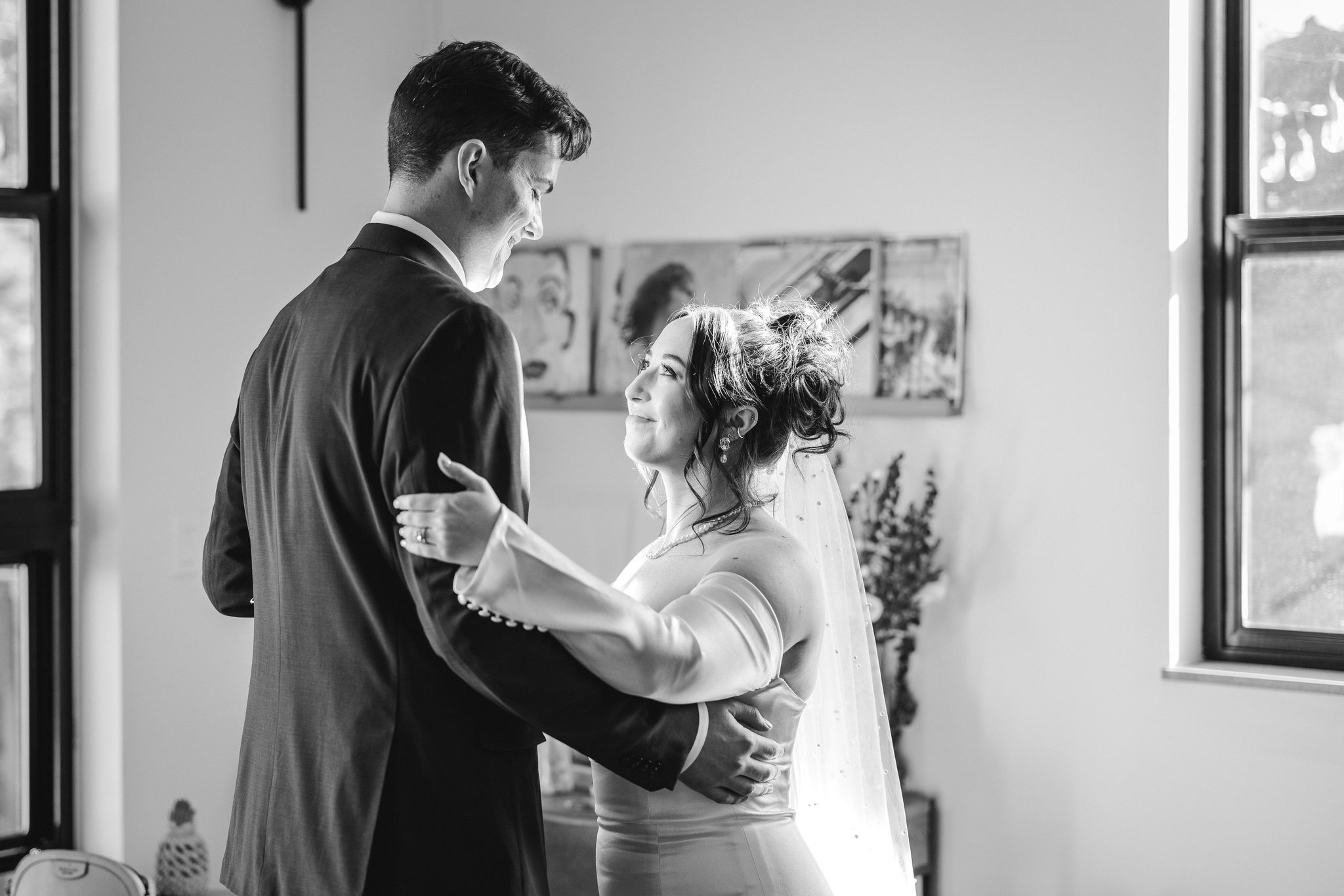 bride looks up at groom as they share an elopement first dance in the airbnb.