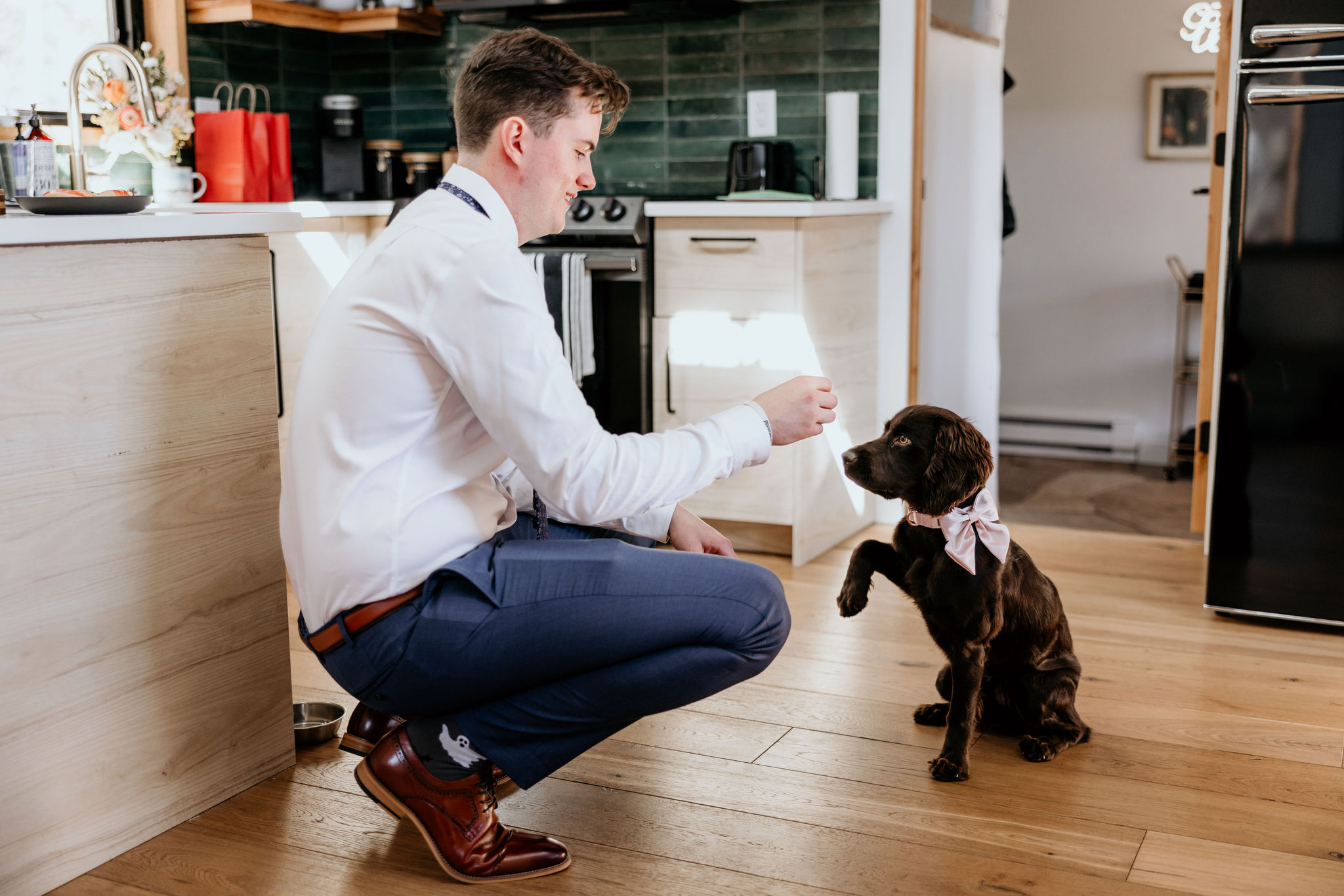 groom plays with dog in colorado airbnb.