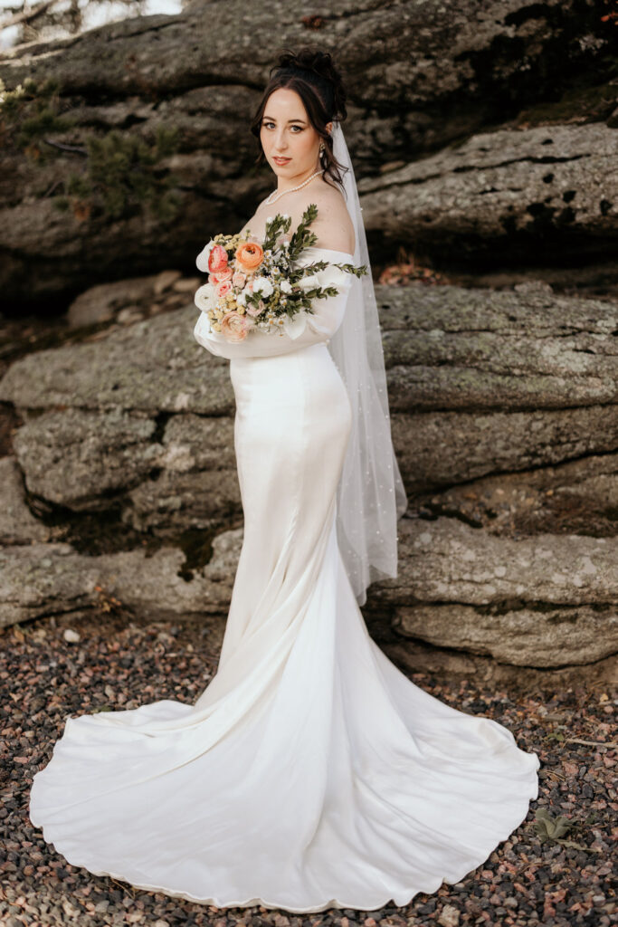 bride poses for wedding portraits in the colorado mountains.