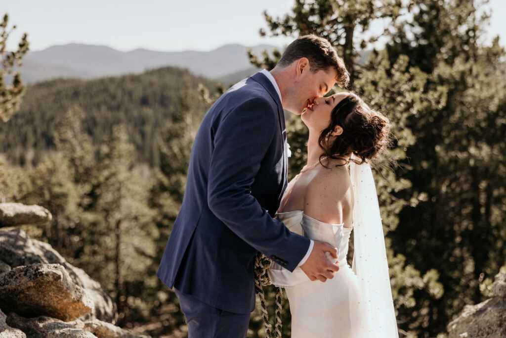 bride and groom kiss during colorado elopement in the mountains.