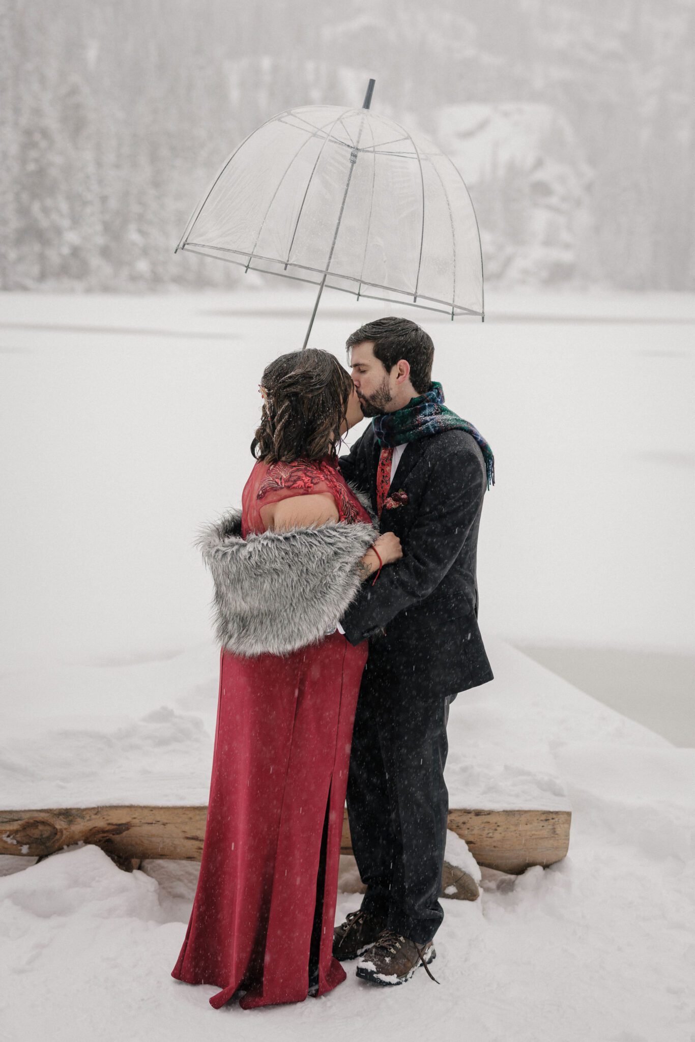 man and woman kiss during photo shoot at rocky mountain national park