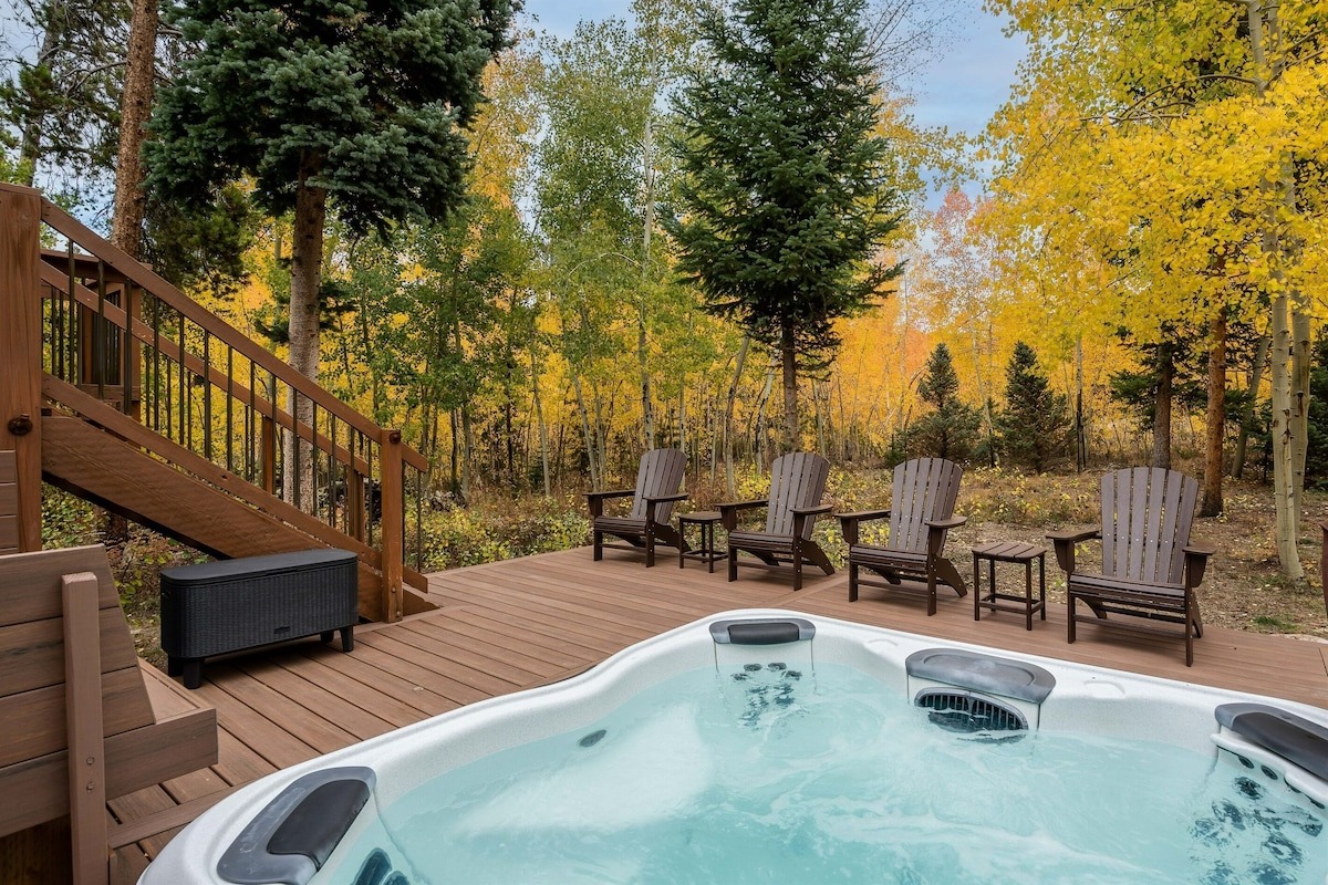 hot tub sits surrounded by gold aspens - colorado airbnb vrbo micro wedding and elopement venue