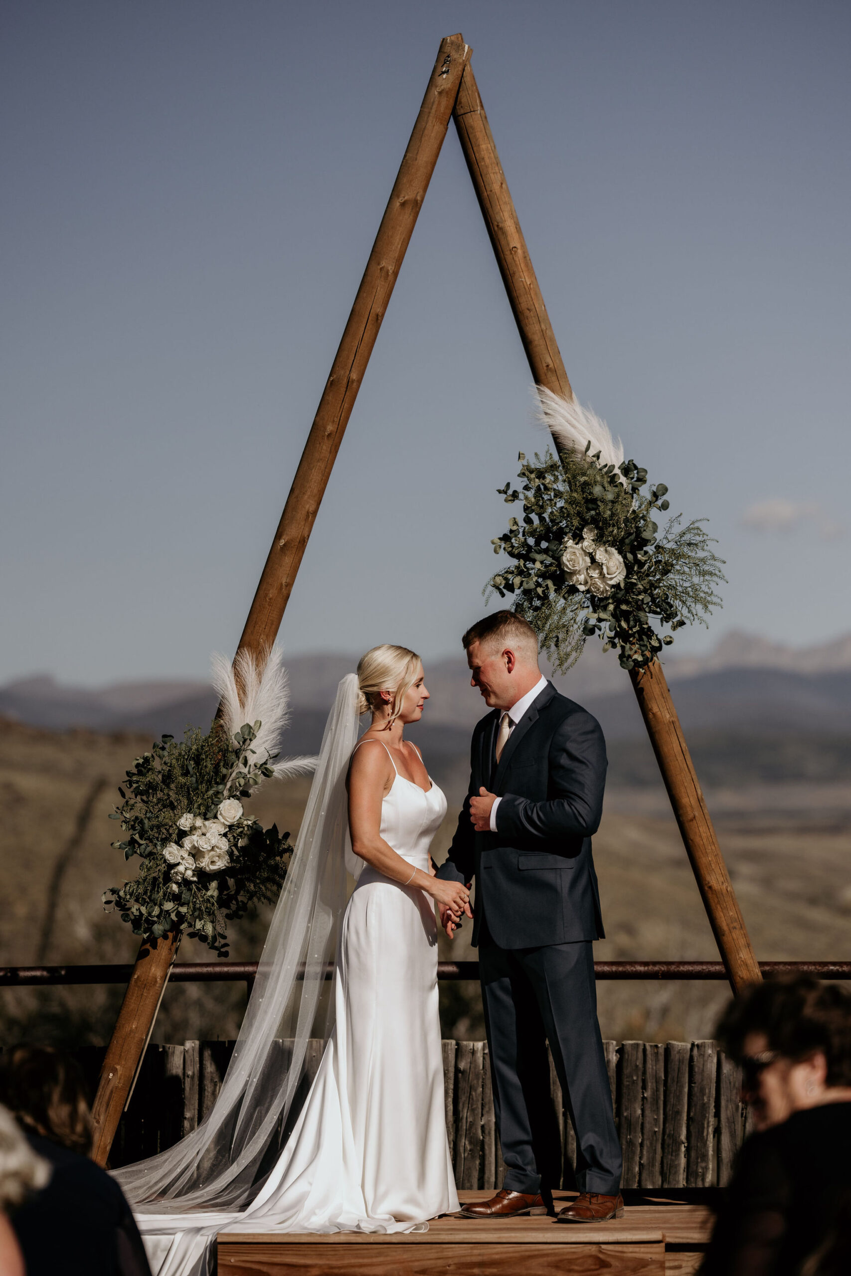 bride and groom stand at altar during colorado mountain wedding.