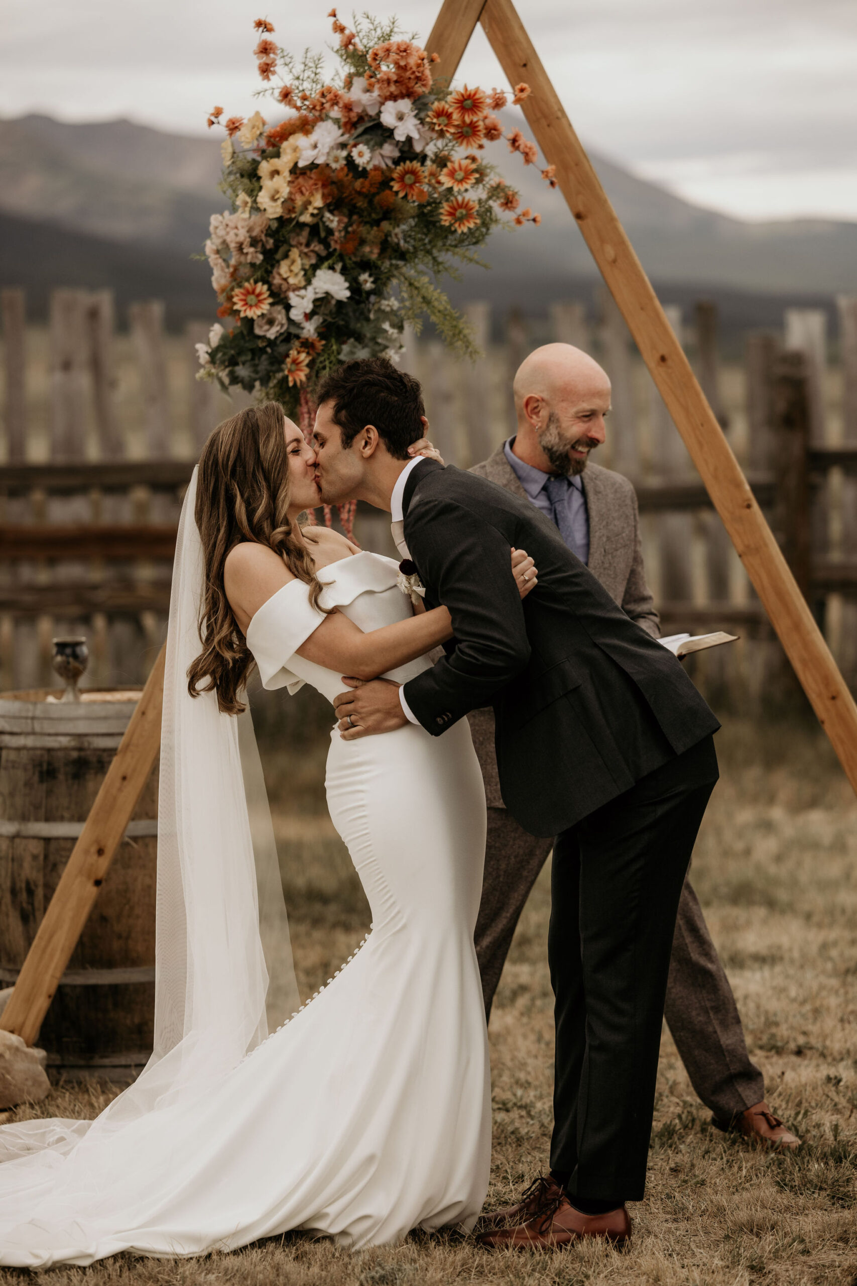 bride and groom kiss during micro wedding ceremony in colorado.