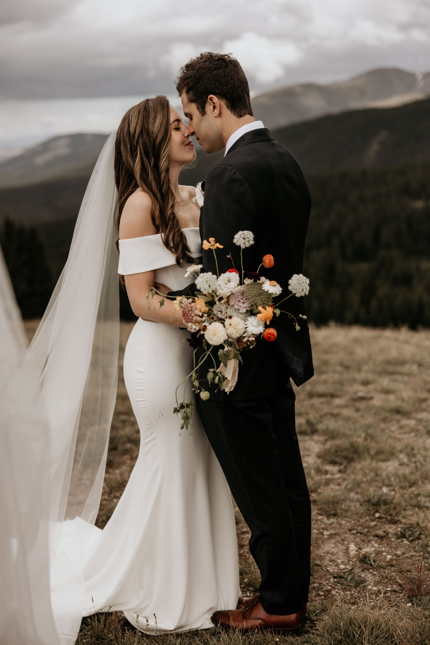 Bride and groom put faces near each other during colorado wedding photo shoot.