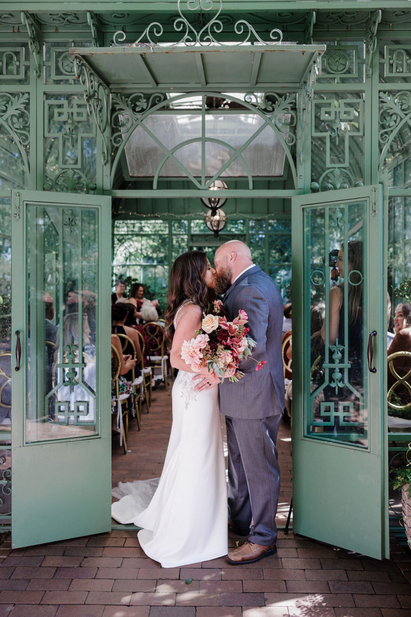 bride and groom kiss after ceremony set up by micro wedding planner