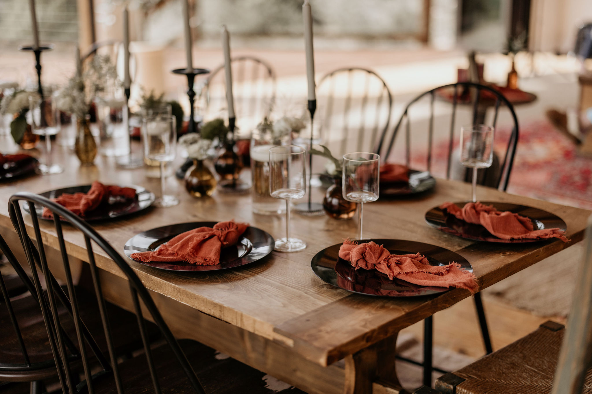 wedding vendor sets up table during private chef dinner at a colorado micro wedding.