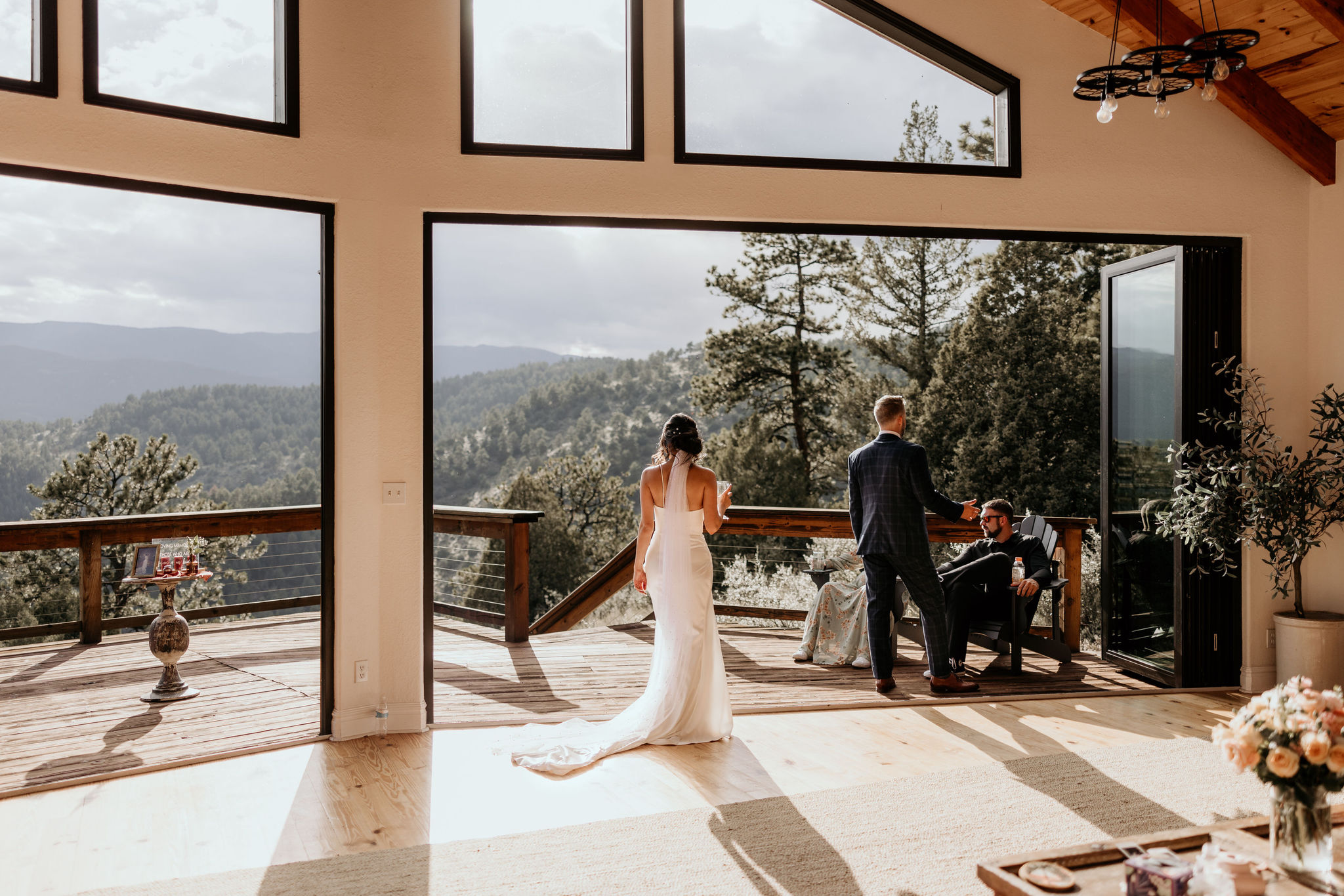 bride and groom stand in open air vacation rental during airbnb micro wedding in the mountains