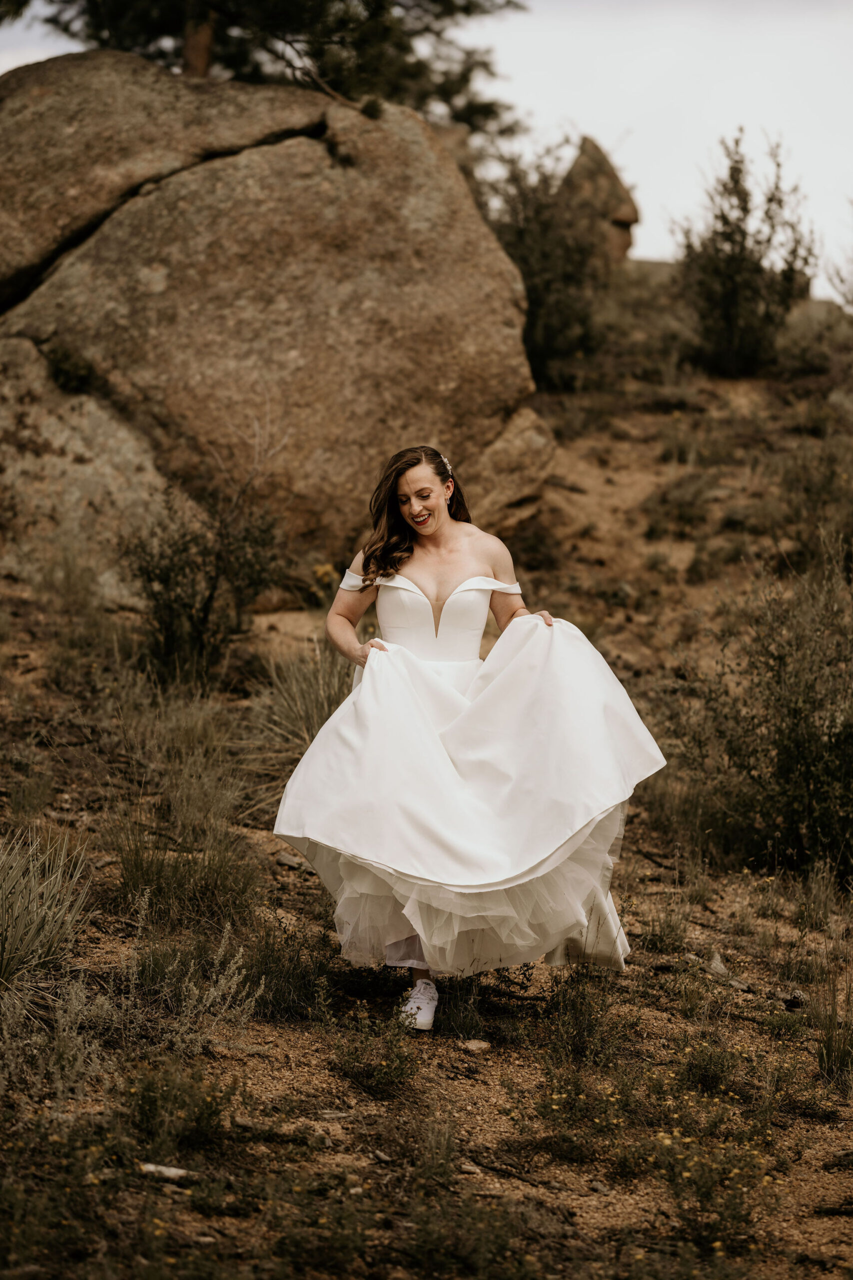 bride walks down a trail during colorado elopement.