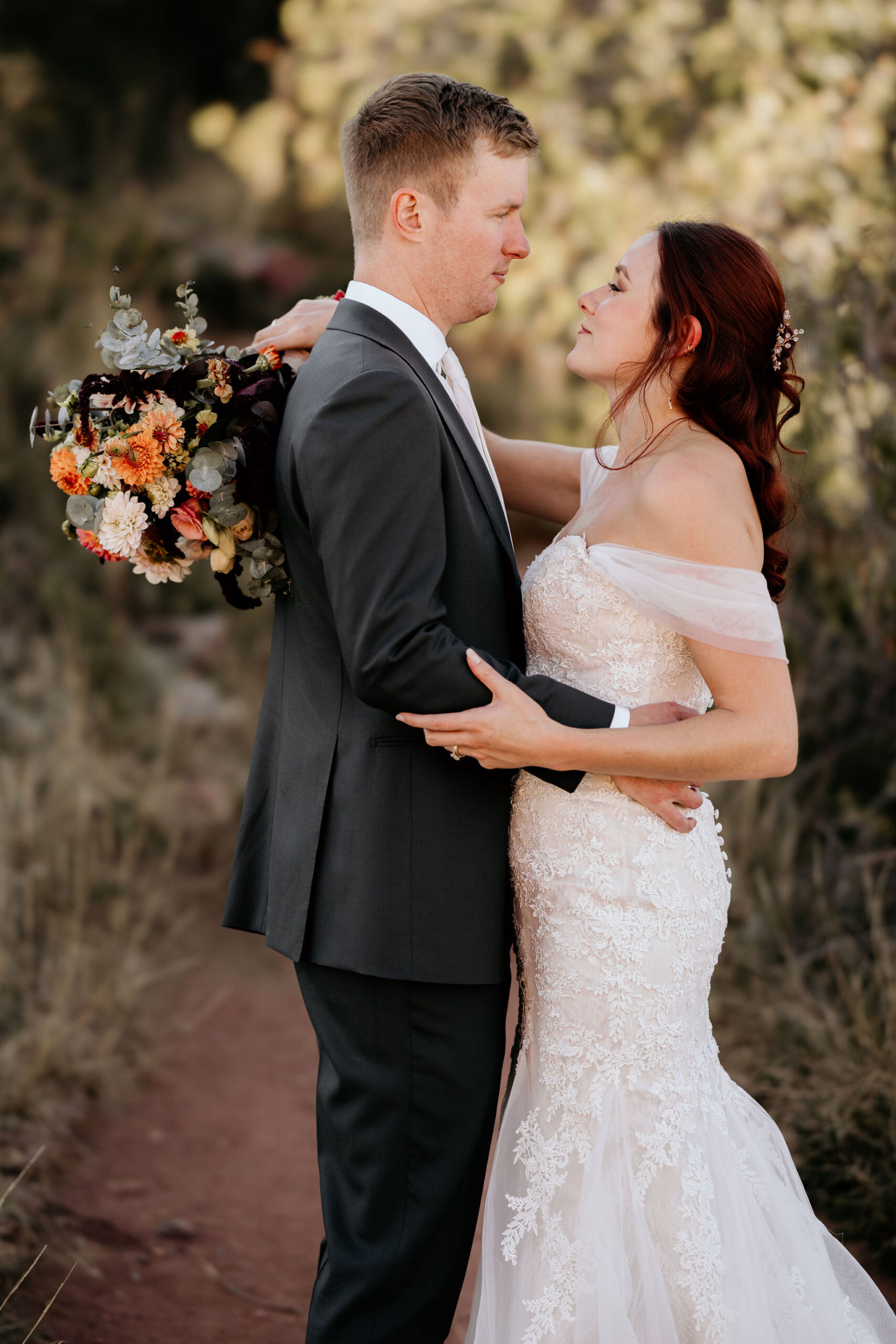 bride and groom embrace during red rocks micro wedding.