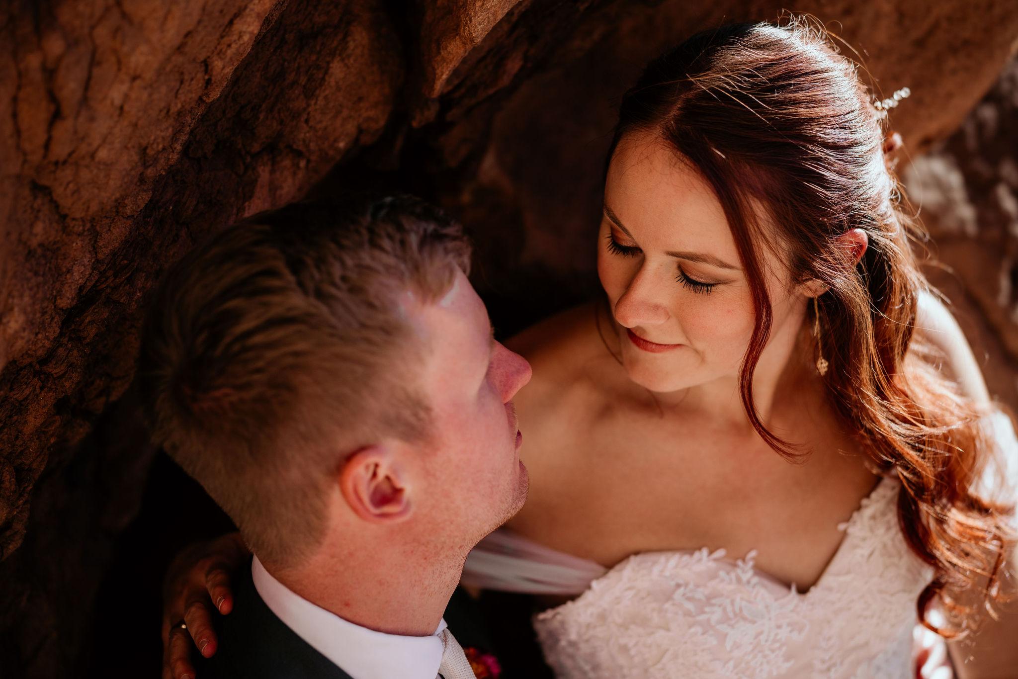 close up image of bride and groom smiling at each other during wedding portraits.