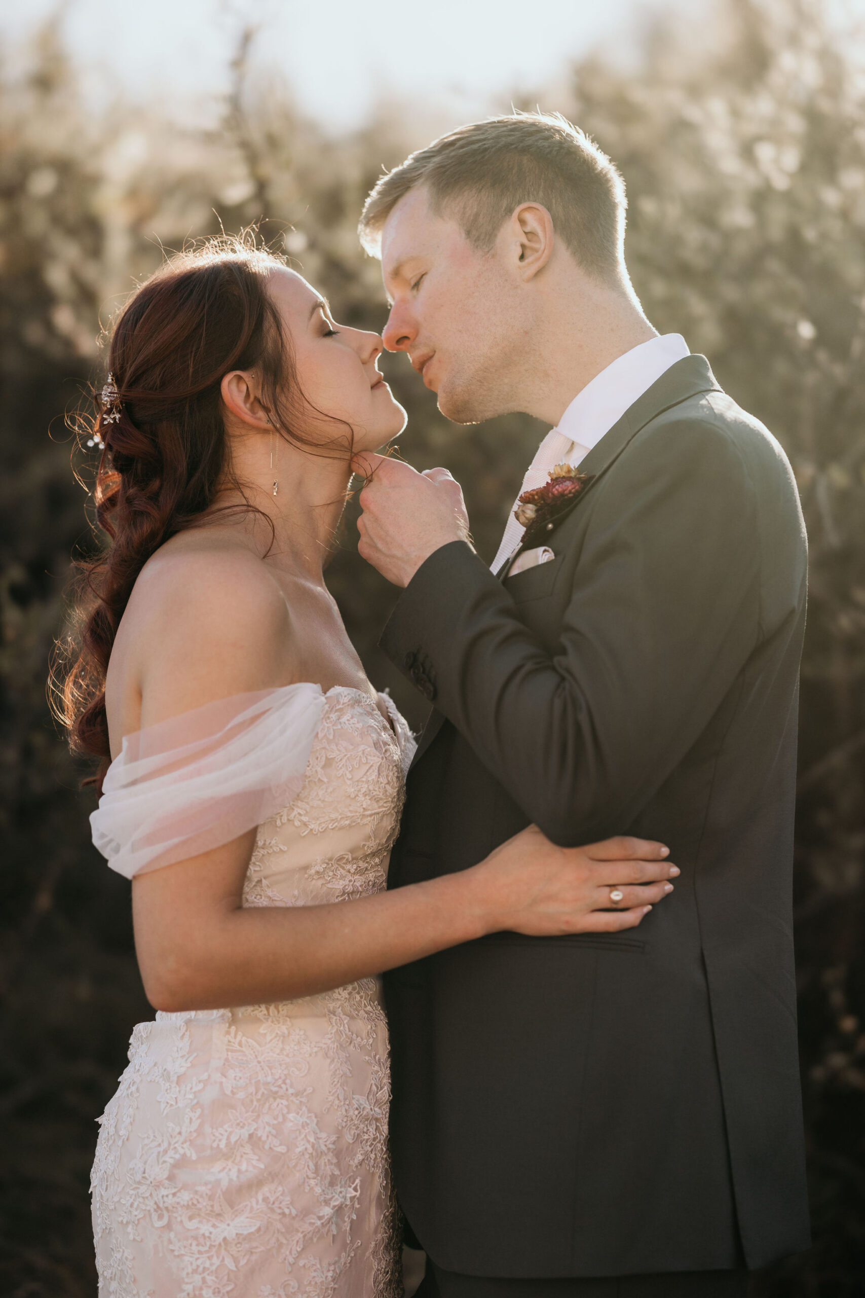 bride and groom go in for a kiss during colorado wedding portraits.