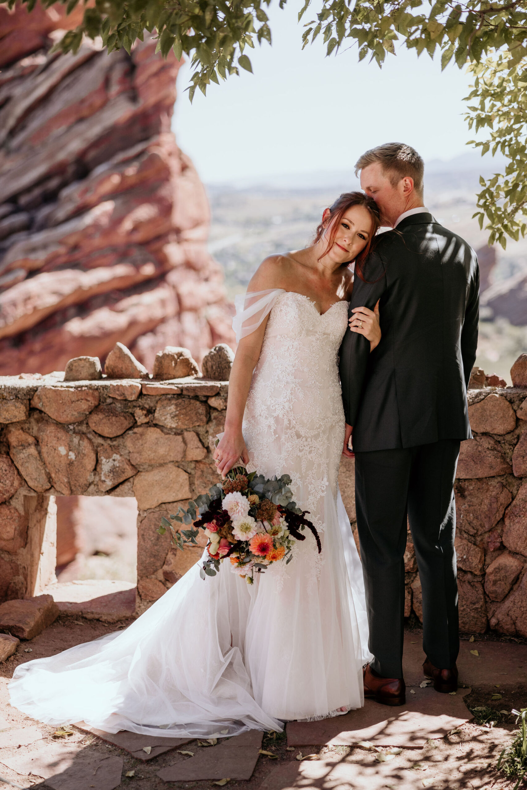 bride and groom pose for bridal portraits at red rocks park and amphitheatre.
