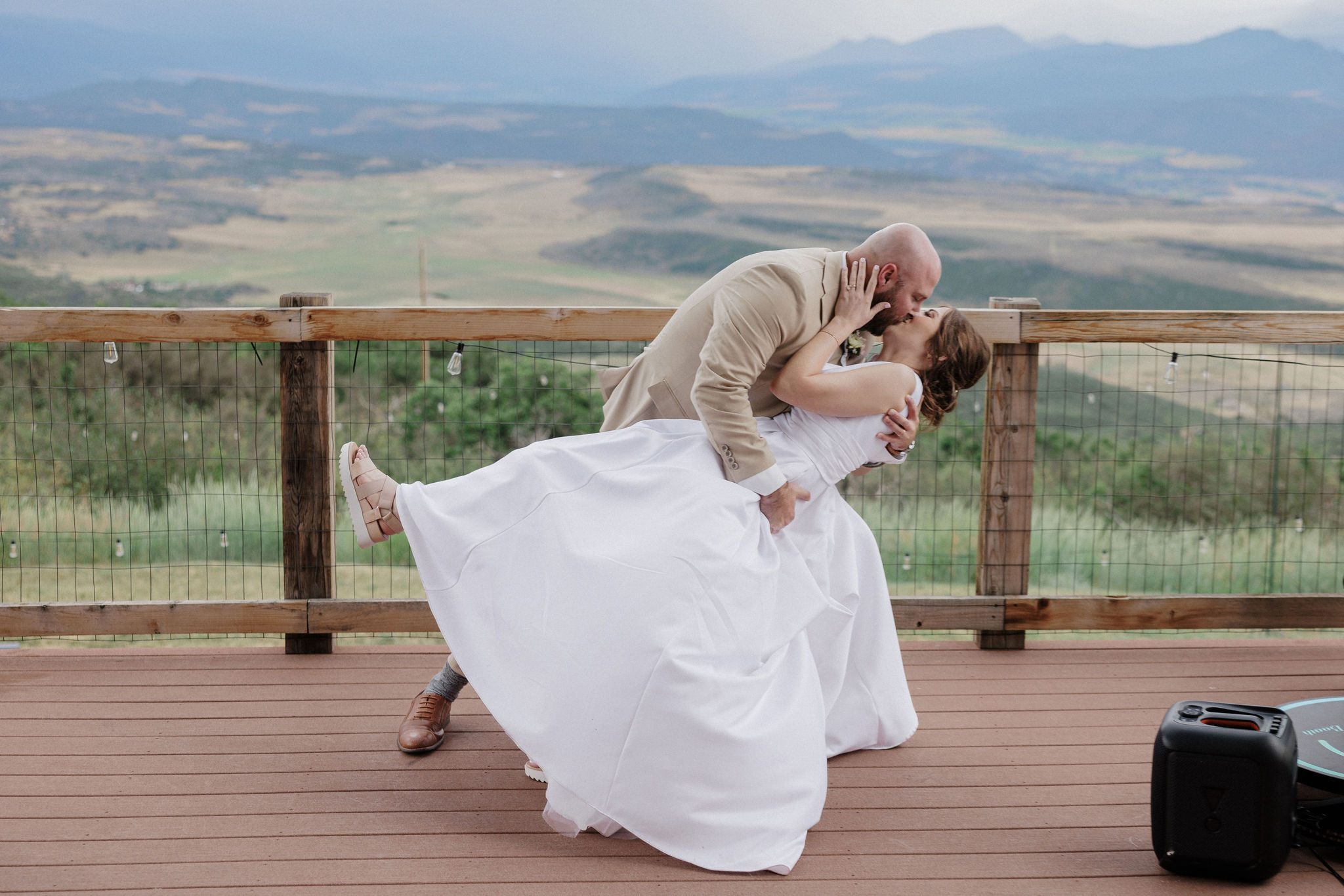 family-style table set upbride and groom dance on deck of Colorado airbnb micro wedding + elopement venue