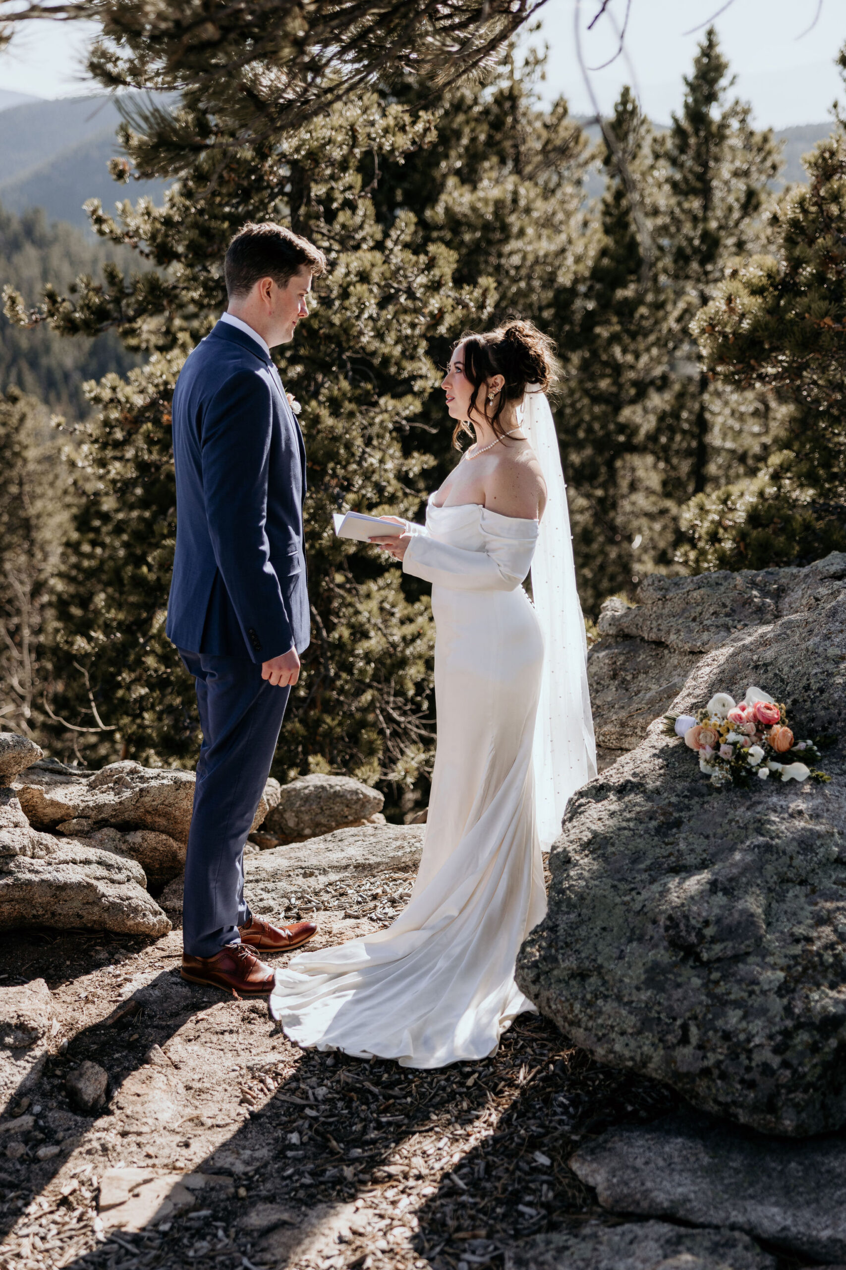 bride and groom stand in colorado mountains during their adventure elopement.