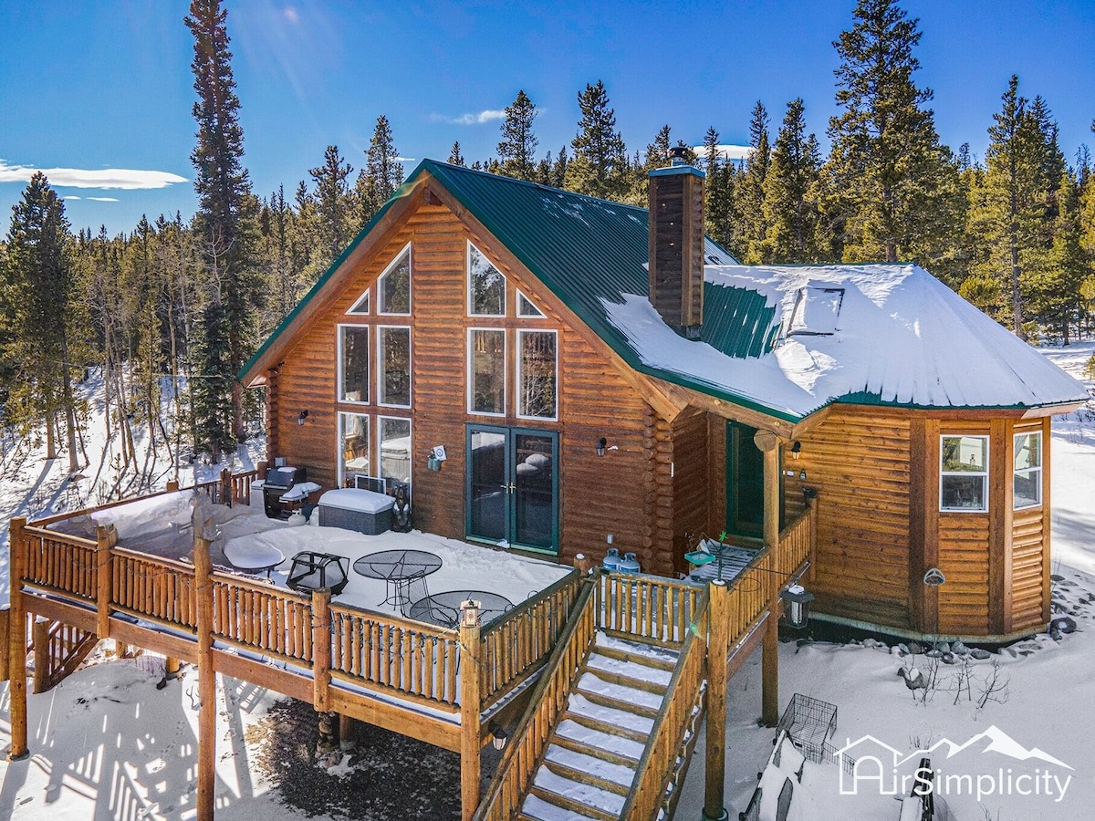 log cabin with deck sits in the mountains - colorado airbnb vrbo micro wedding + elopement venue 