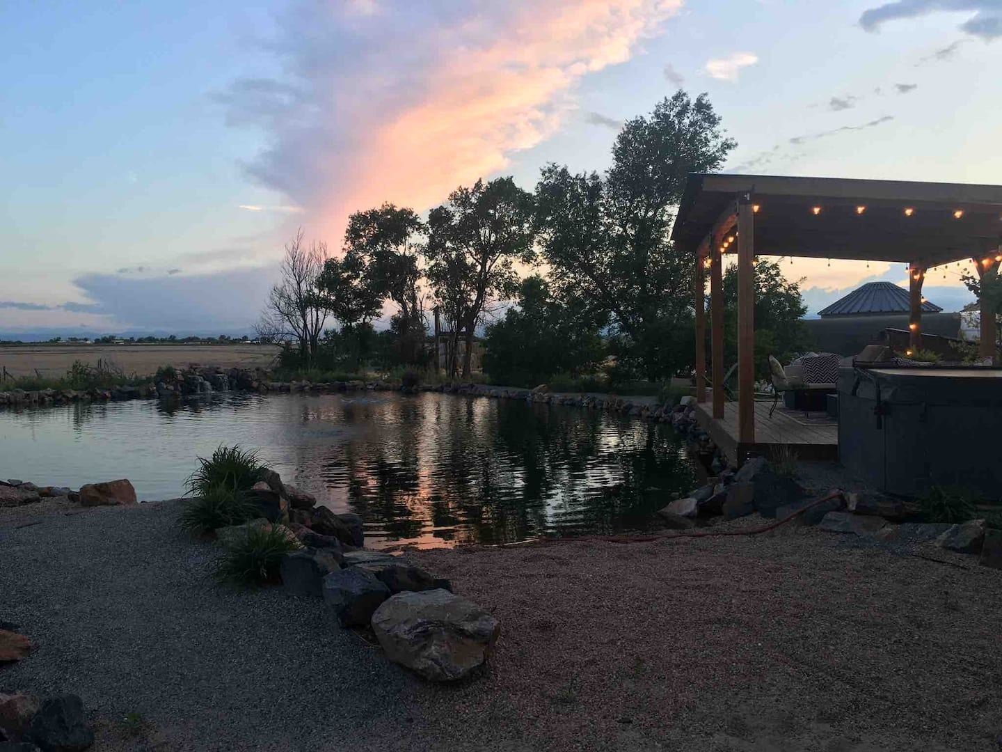 lounge set up with lights by a pond - colorado airbnb / vrbo micro wedding venue near denver