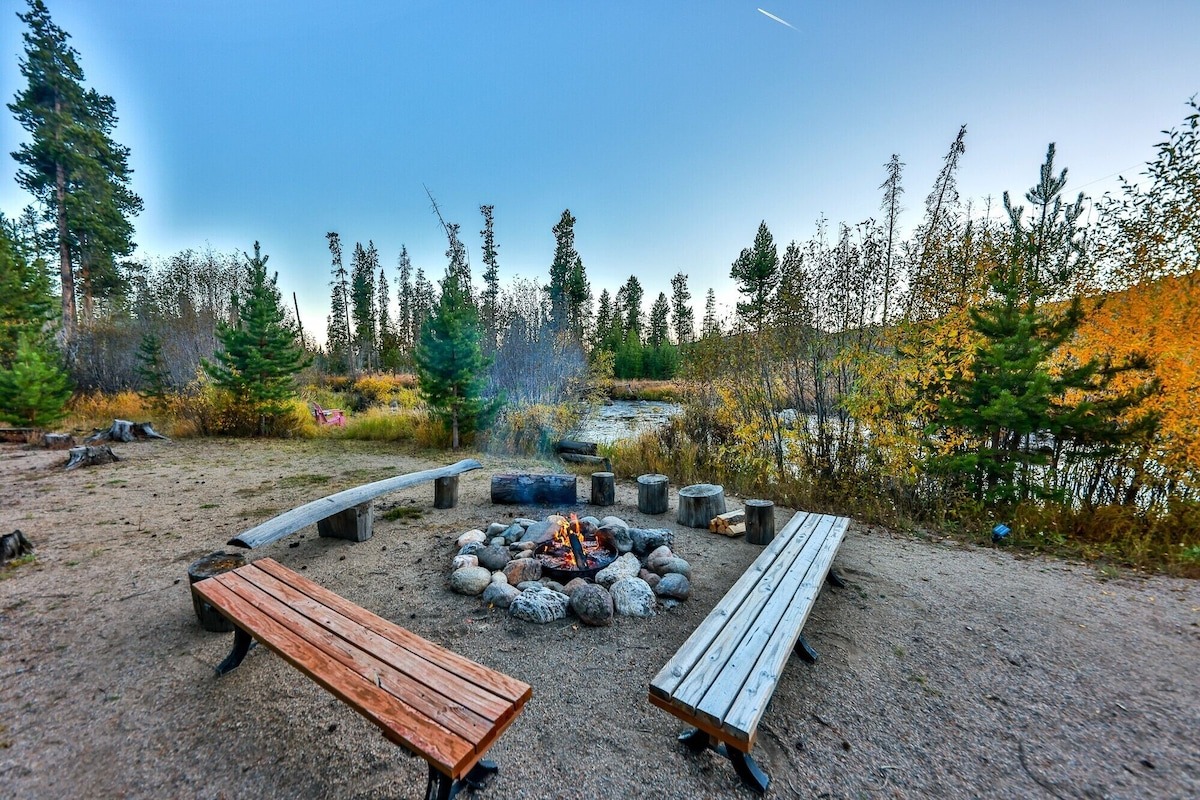 chairs and benches set up around firepit at log cabin in the mountains - colorado vrbo micro wedding + elopement venue