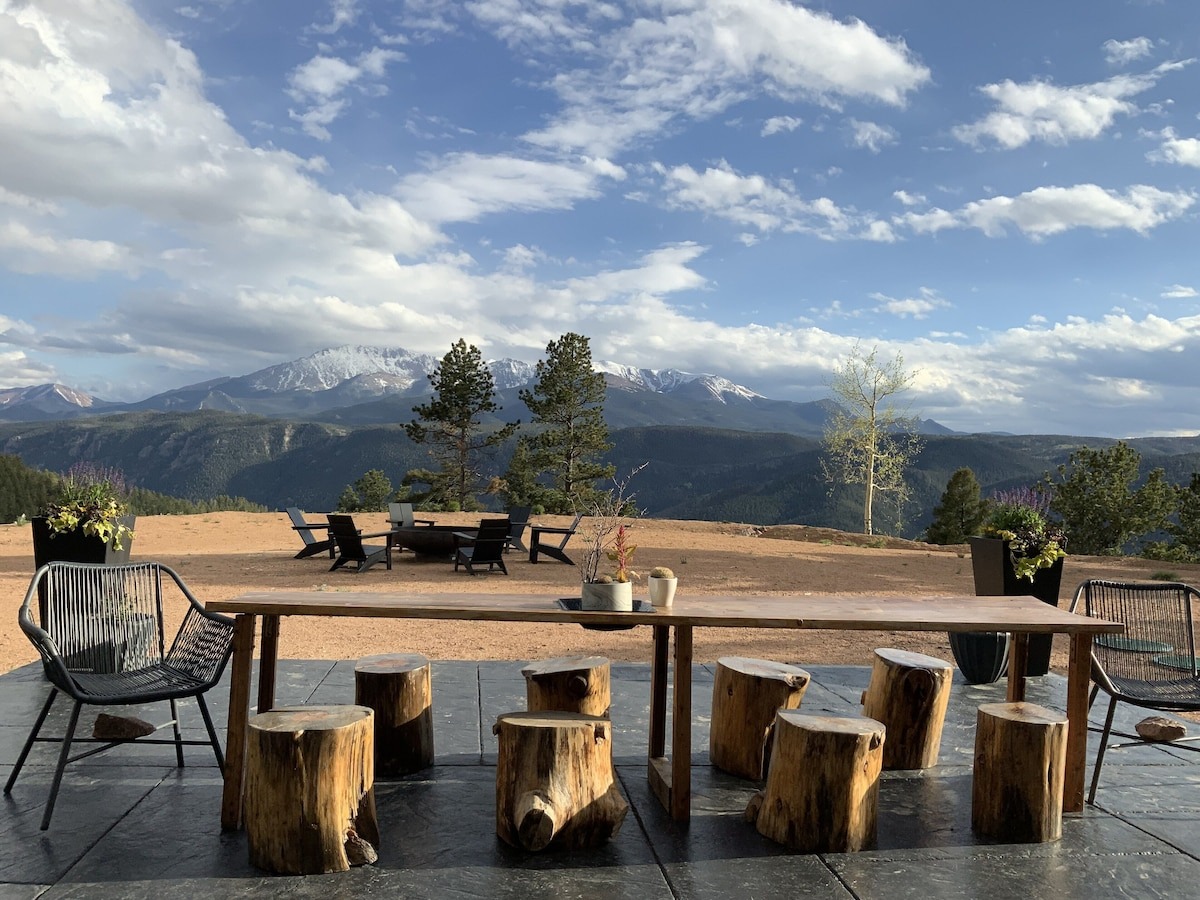 colorado vrbo micro wedding + elopement venue - table set up with log stools overlooking the mountains